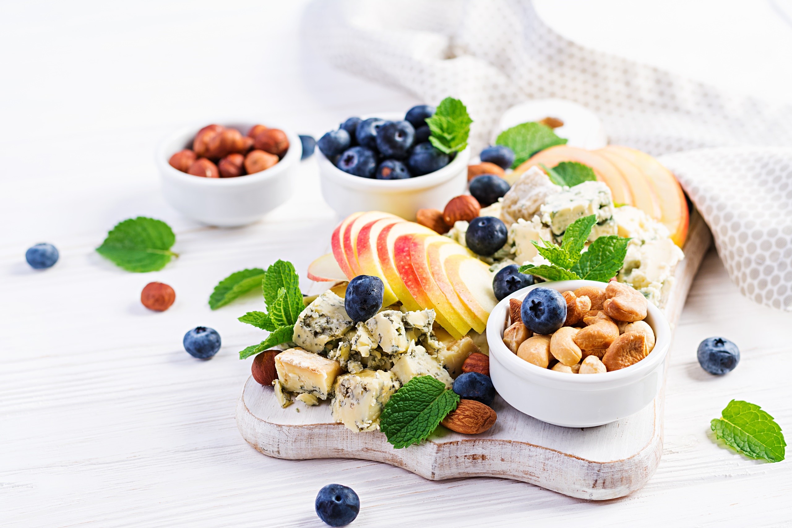 Cheese board with blueberries, nuts, and apples HD Wallpaper