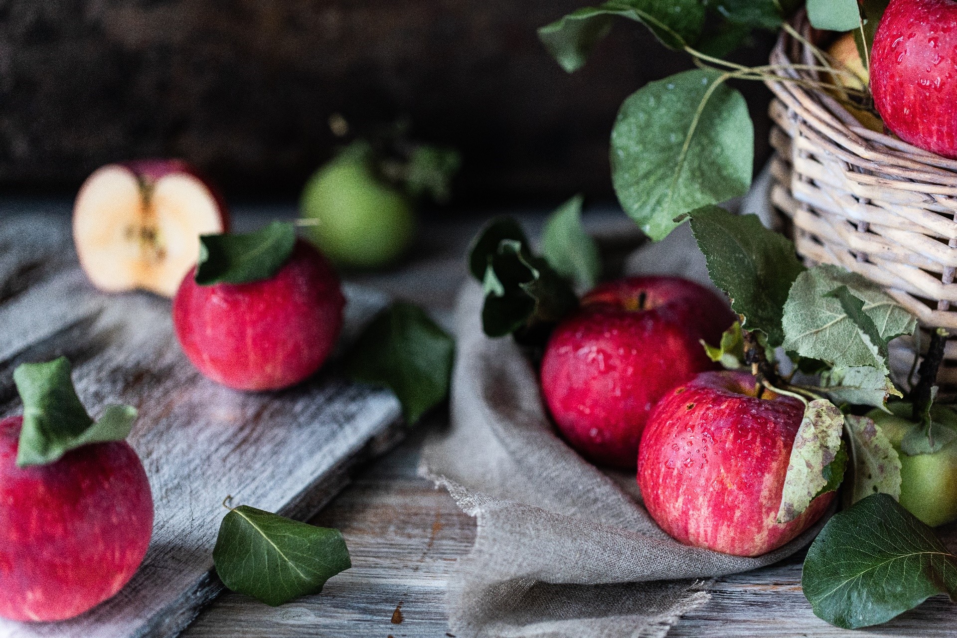 Apples and leaves on a wooden surface HD Wallpaper