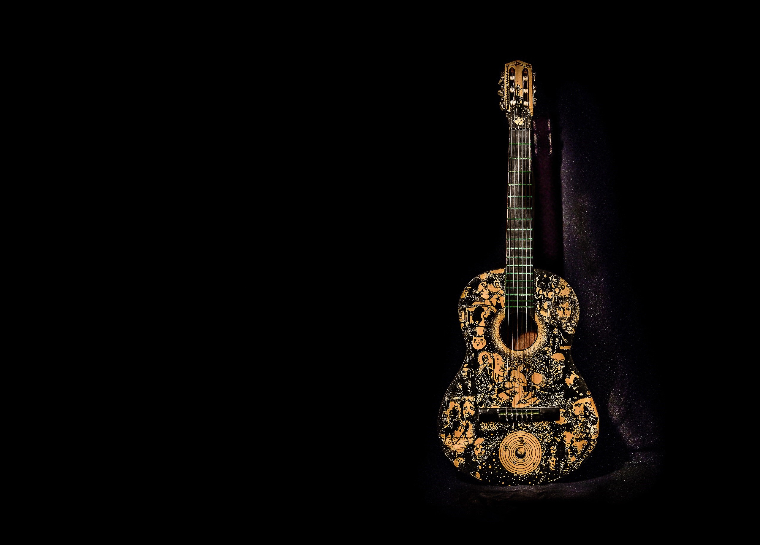 Acoustic guitar with intricate black and gold designs HD Wallpaper