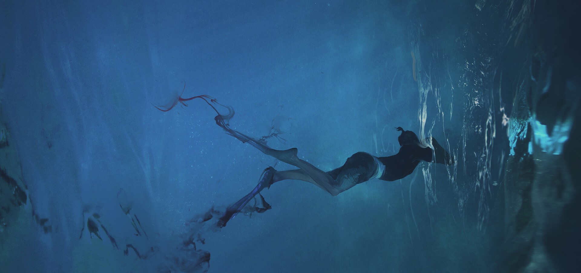 Person swimming underwater with red tendrils HD Wallpaper