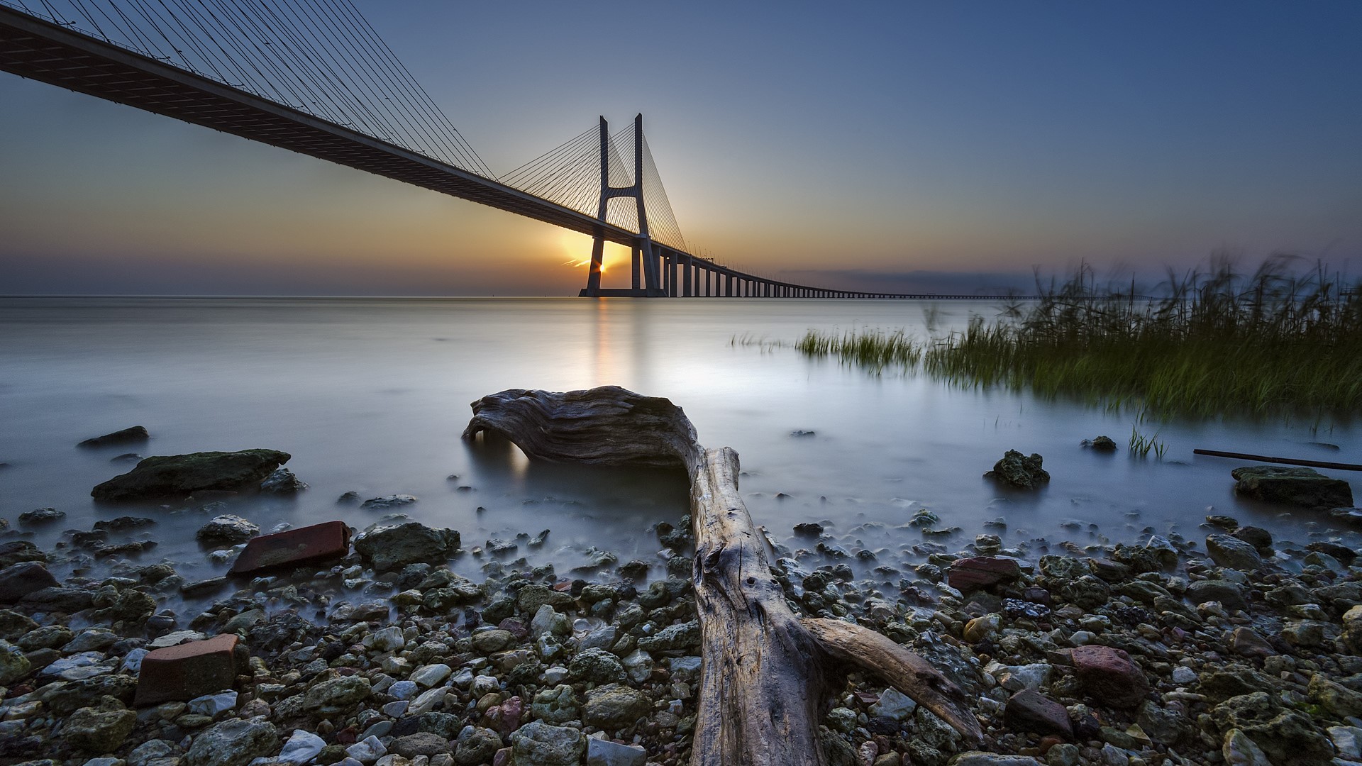 Vasco da Gama Bridge at sunset in Lisbon, Portugal HD Wallpaper