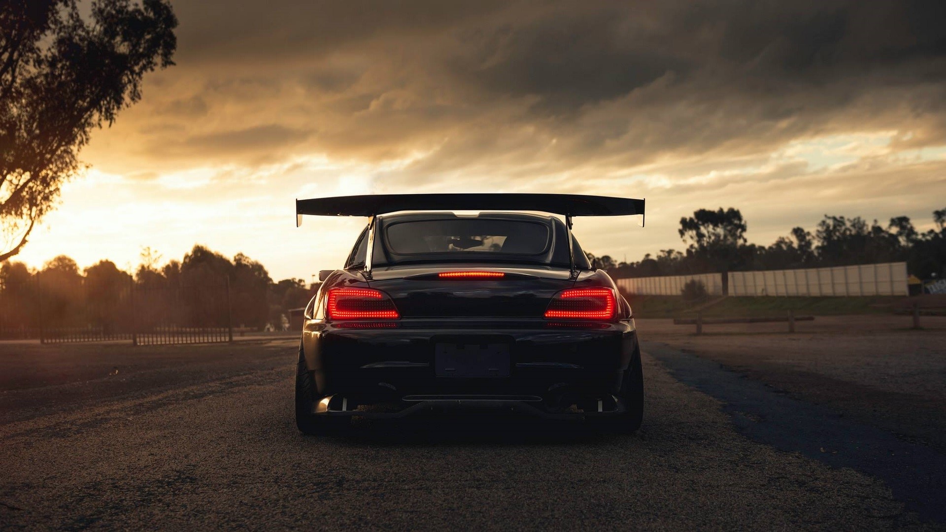 Black Honda S2000 with large rear wing at sunset HD Wallpaper