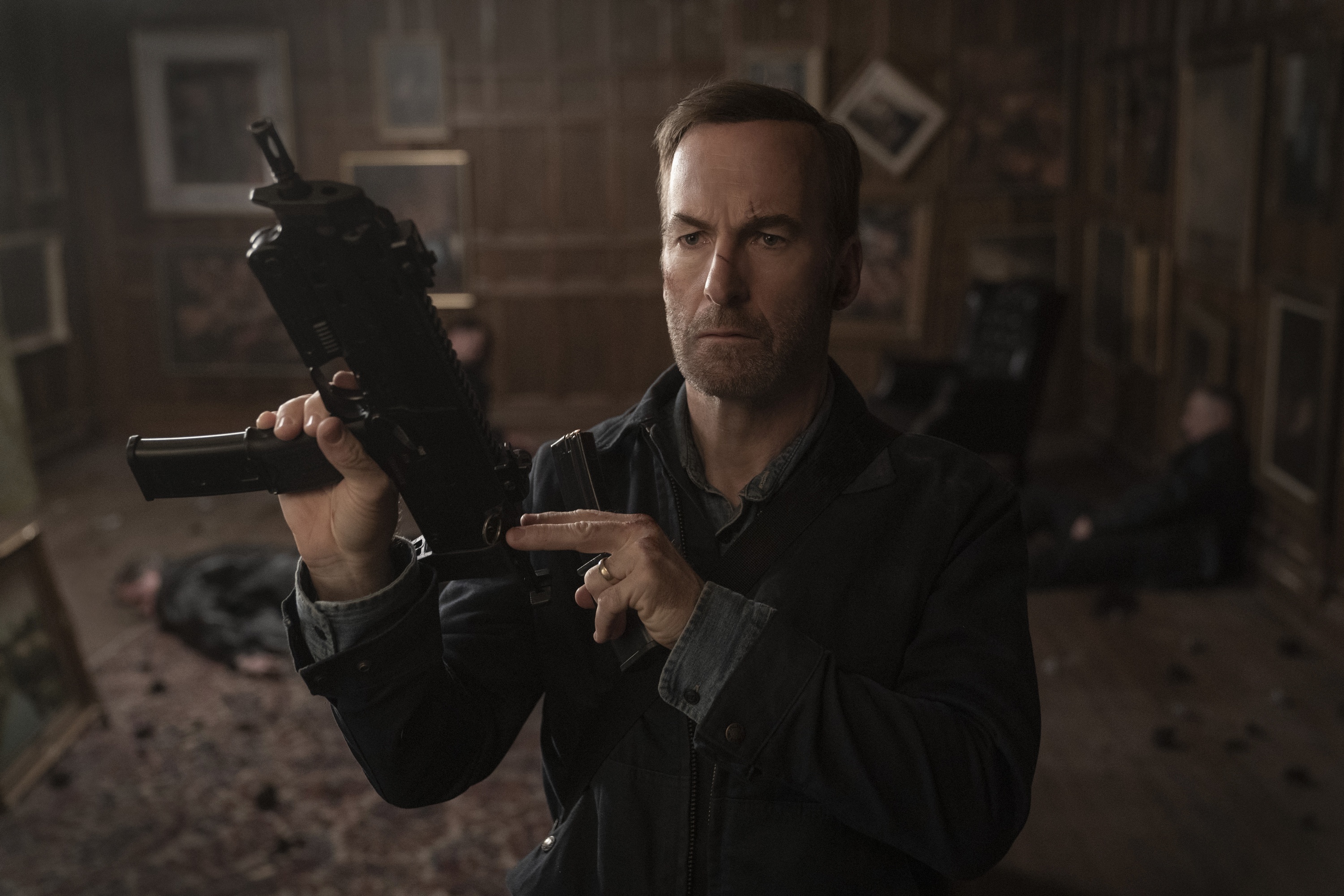 Bob Odenkirk holds a submachine gun in Nobody HD Wallpaper