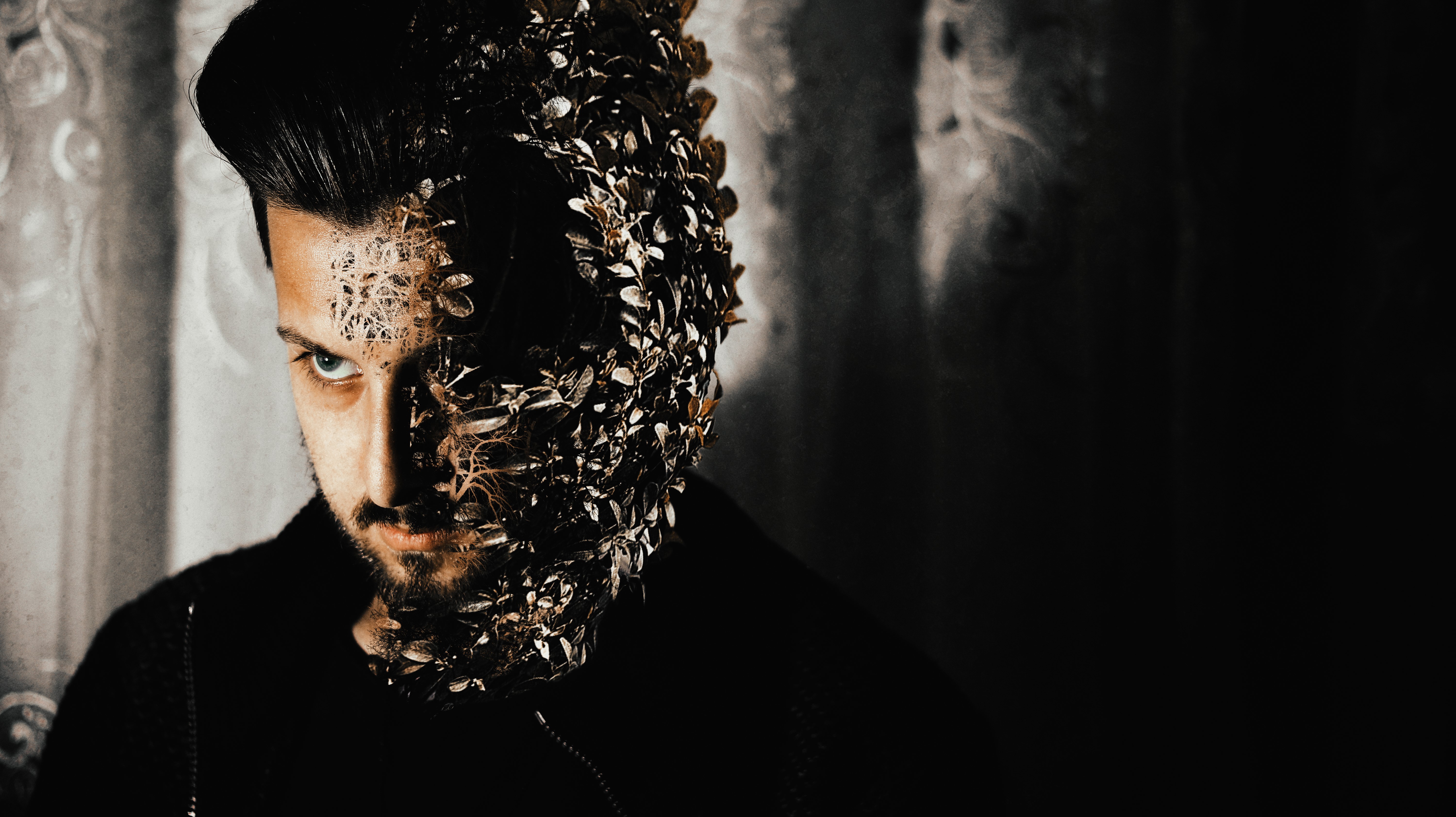 Man with half face covered in leaves HD Wallpaper
