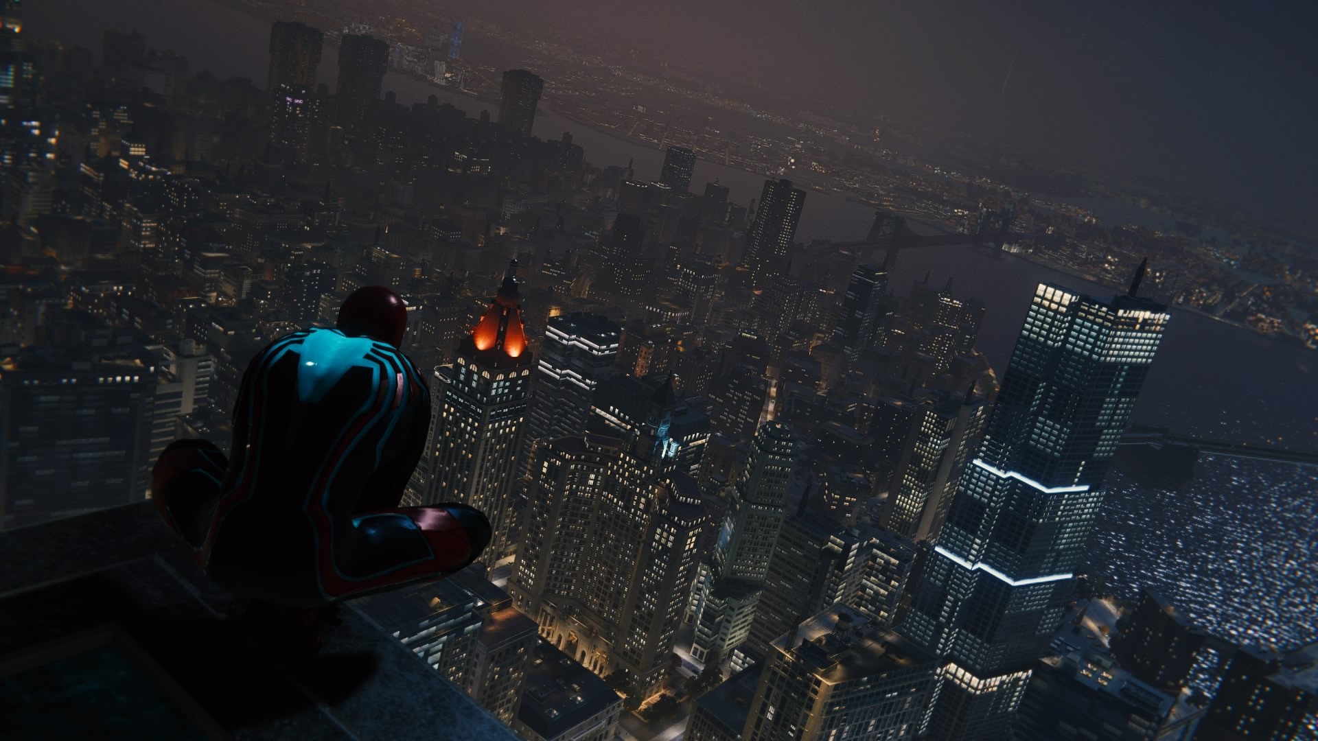 Spider-Man sitting on a skyscraper overlooking a city at night HD Wallpaper