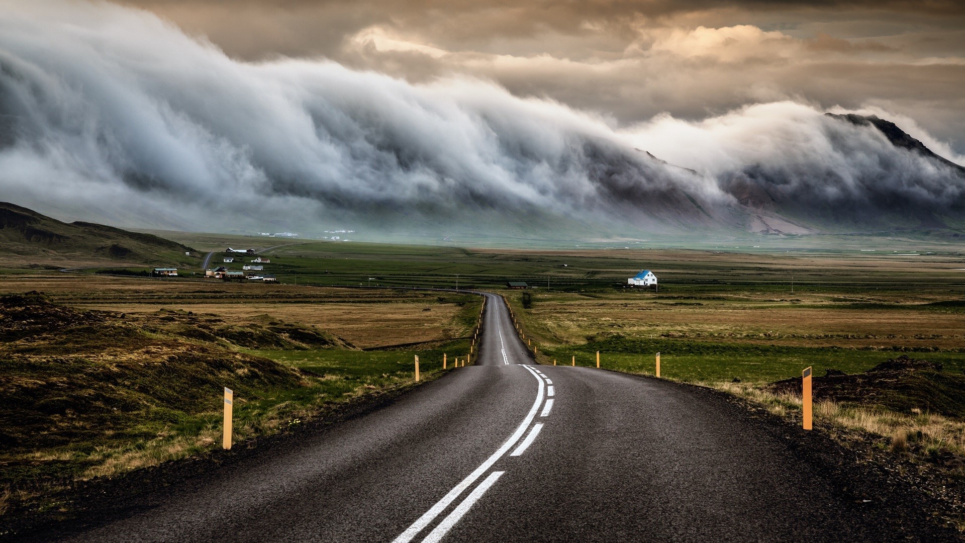 Road leading to mountains with dramatic clouds HD Wallpaper