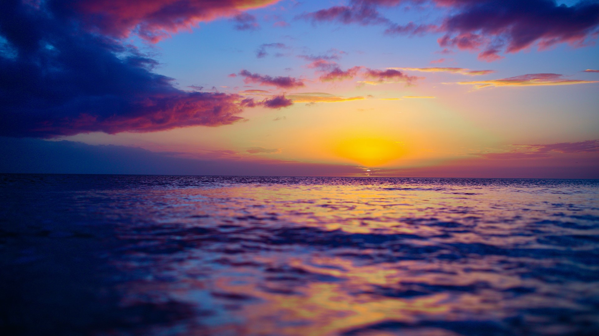 Sunset over the ocean with colorful clouds HD Wallpaper