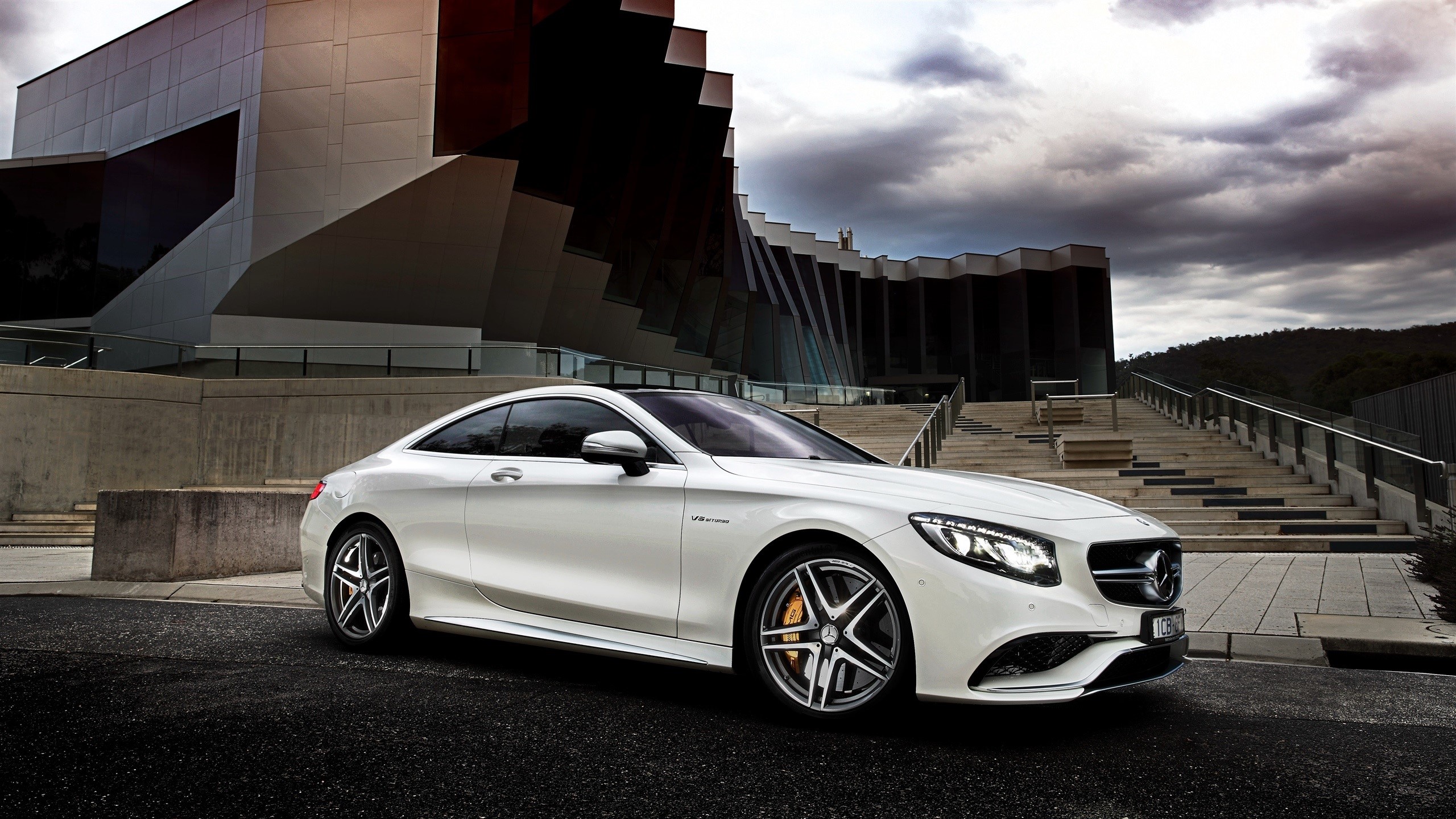 White Mercedes-Benz S-Class Coupe in front of modern architecture HD Wallpaper