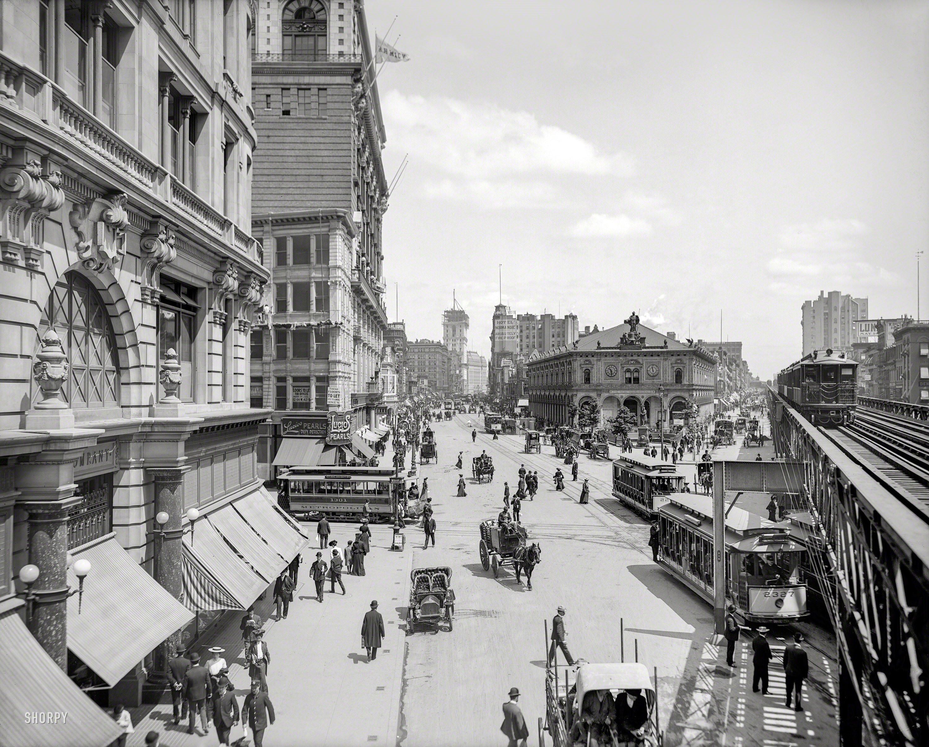 Street scene with horse-drawn carriages and trolleys in New York City HD Wallpaper
