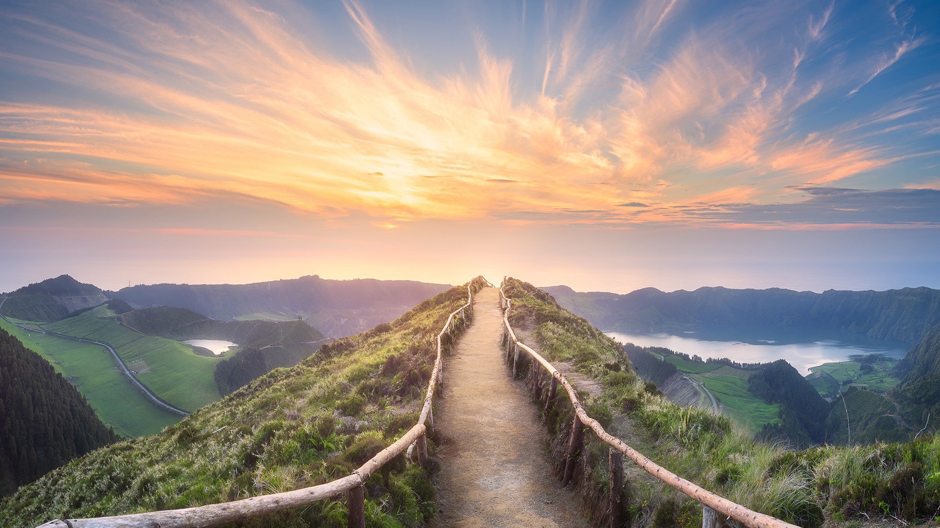 Scenic mountain path with lakes and dramatic sunset sky HD Wallpaper