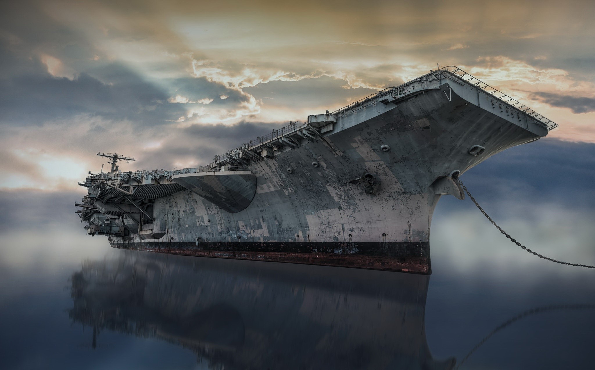 An abandoned aircraft carrier, USS John F. Kennedy, floats on the water HD Wallpaper