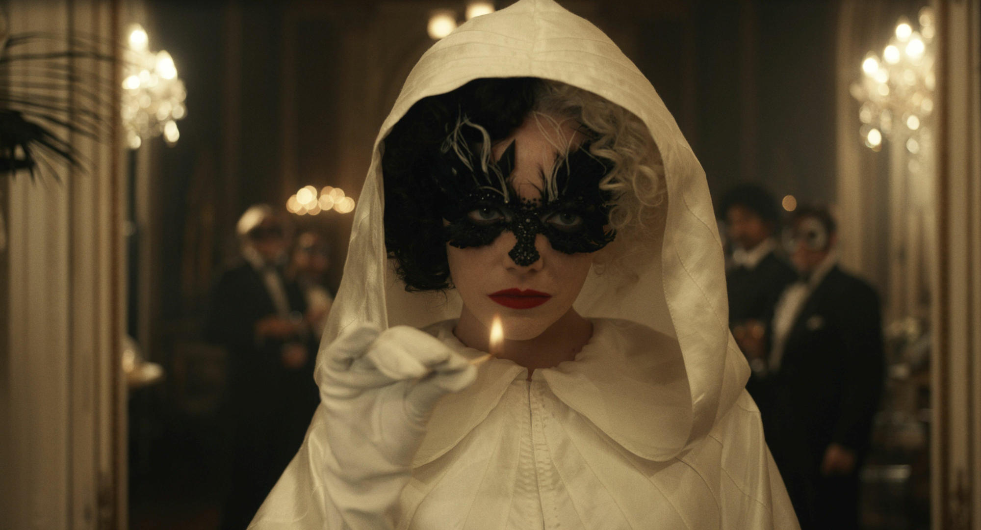 Emma Stone as Cruella holding a lit match HD Wallpaper