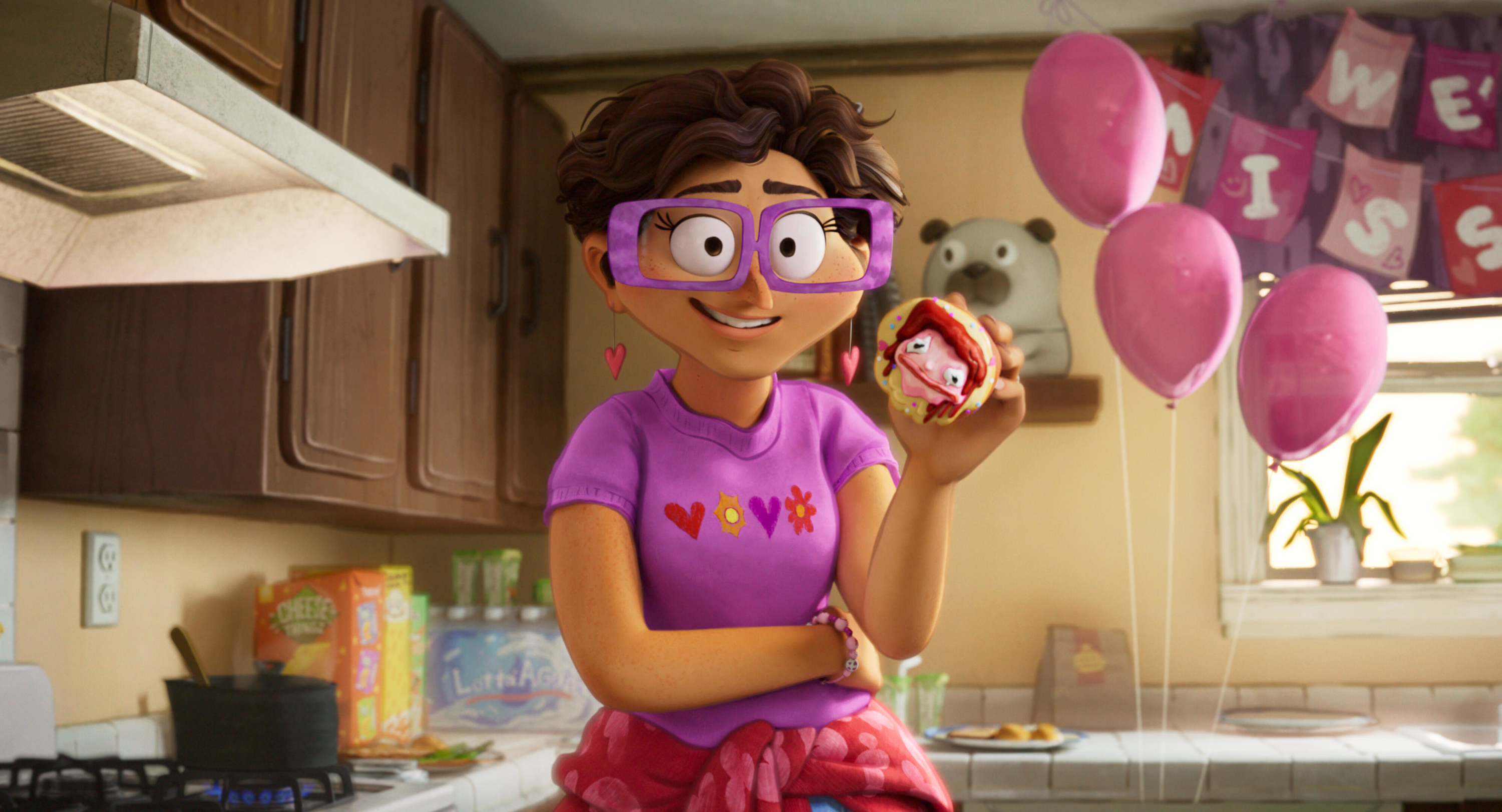 Linda Mitchell holding a decorated donut HD Wallpaper