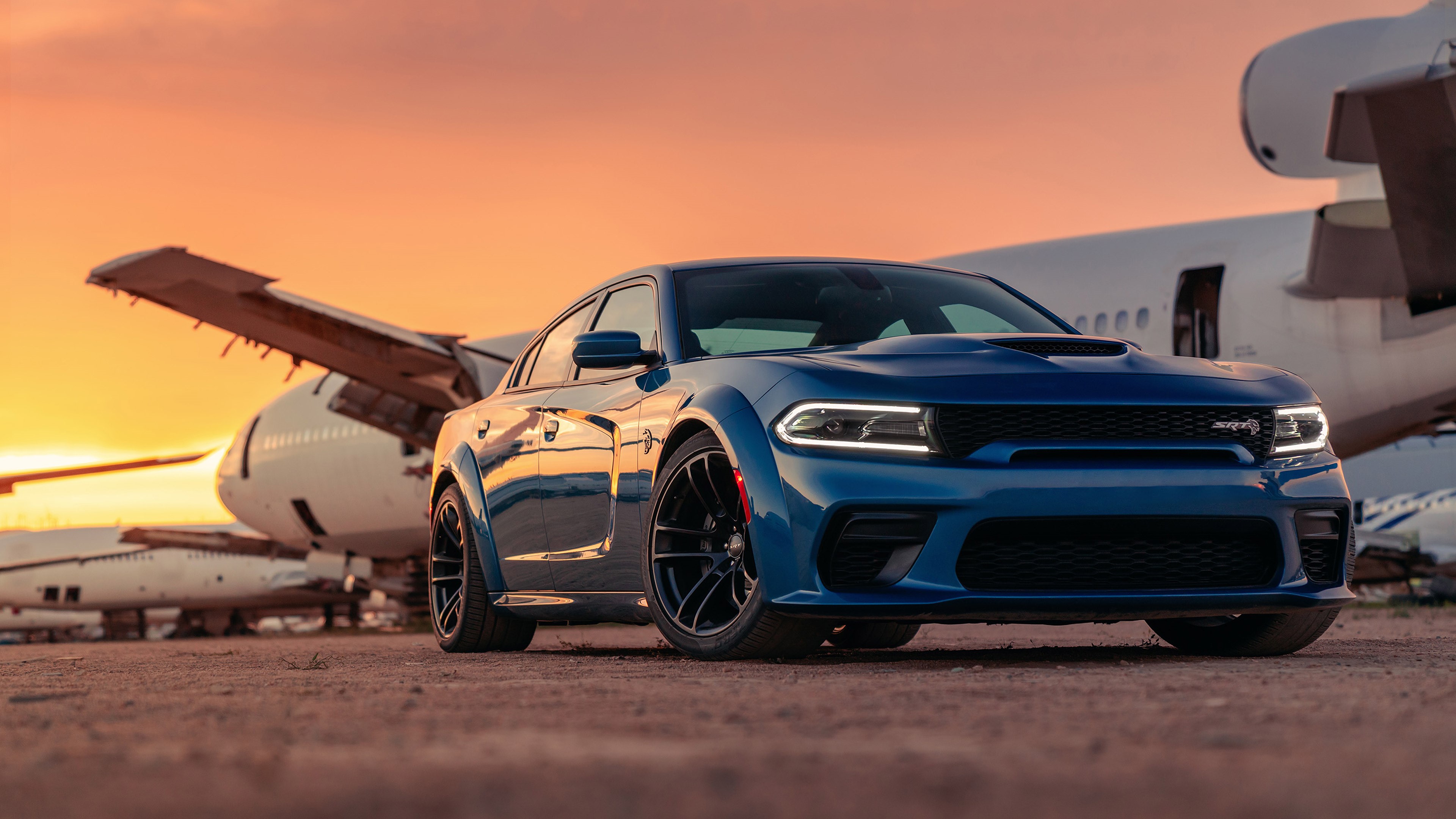 Blue Dodge Charger SRT Hellcat parked near airplanes HD Wallpaper