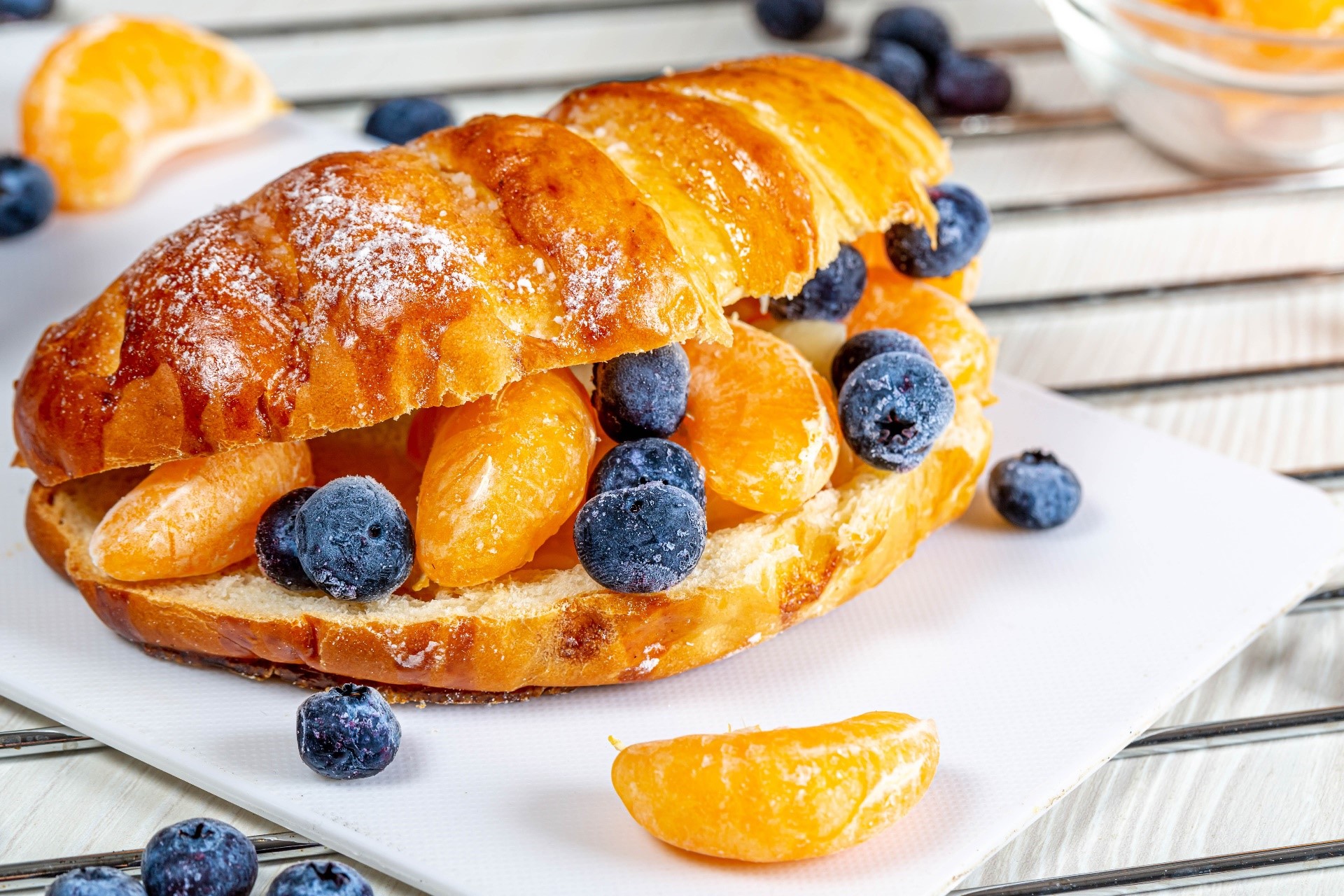 Croissant sandwich with blueberries and tangerine slices HD Wallpaper