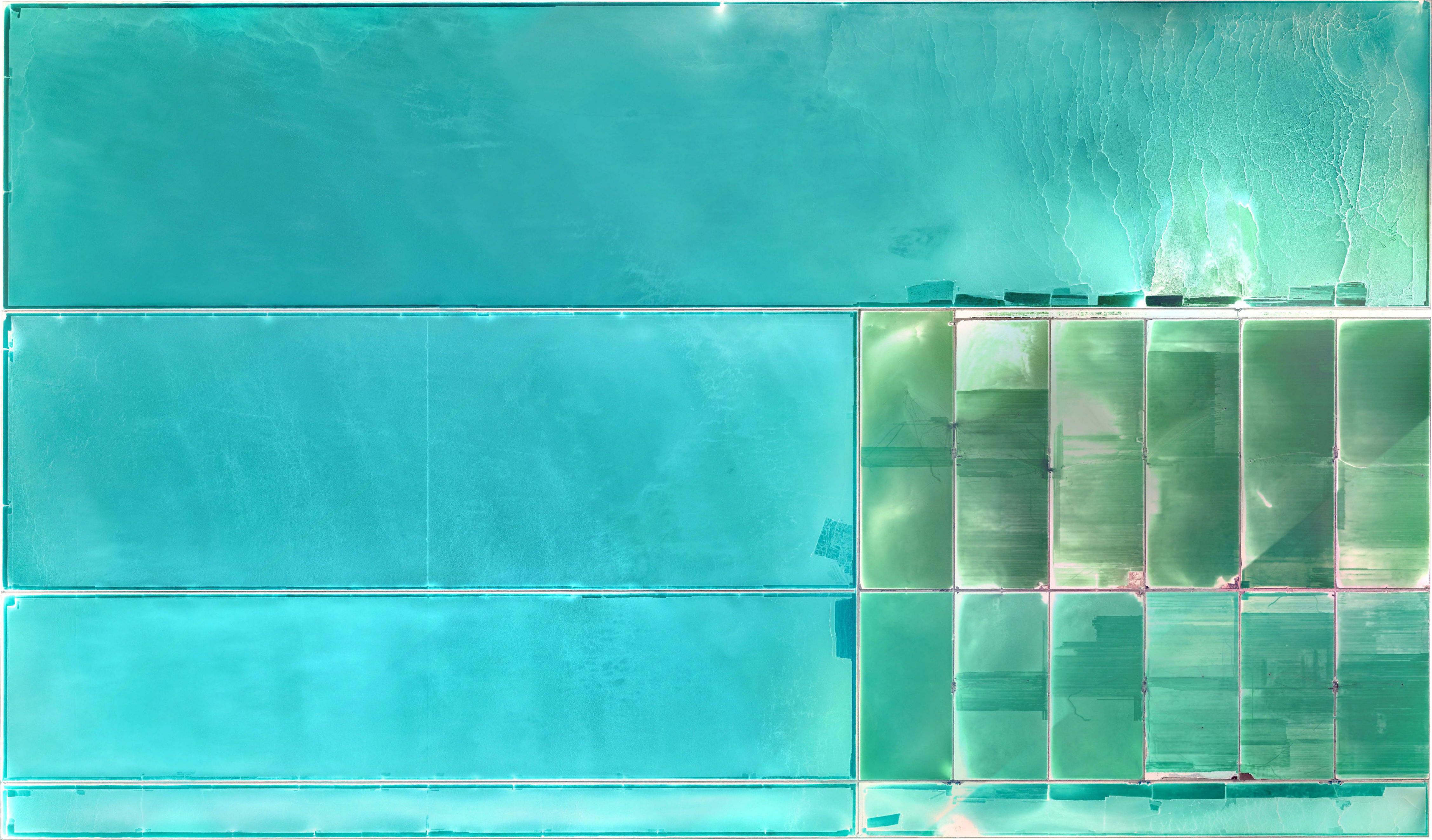Aerial view of salt flats with cyan and green water HD Wallpaper
