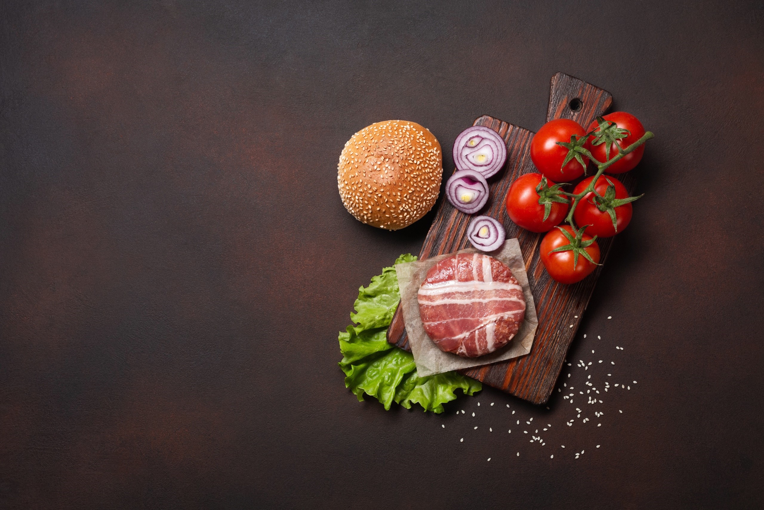 Burger ingredients on a cutting board HD Wallpaper