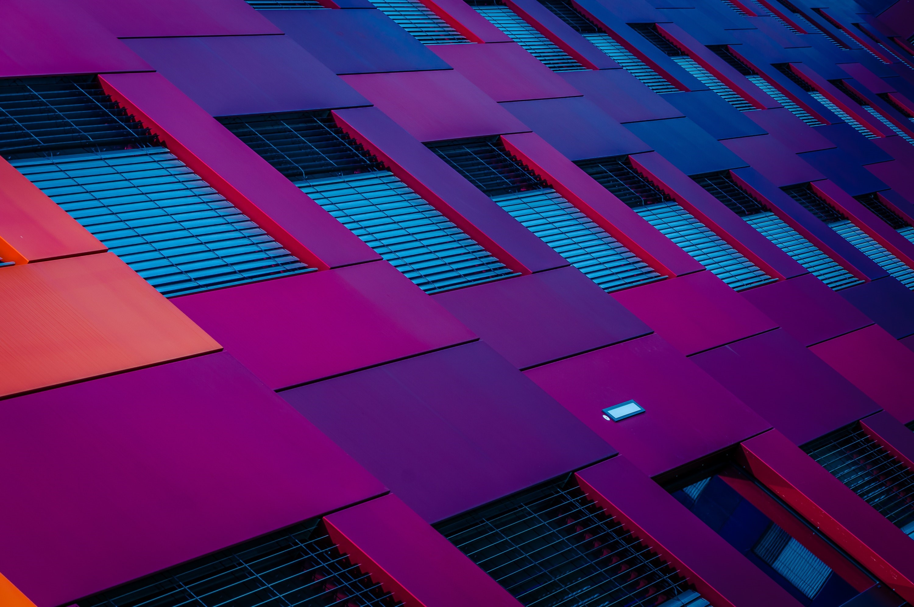 Modern building facade with purple and orange panels HD Wallpaper