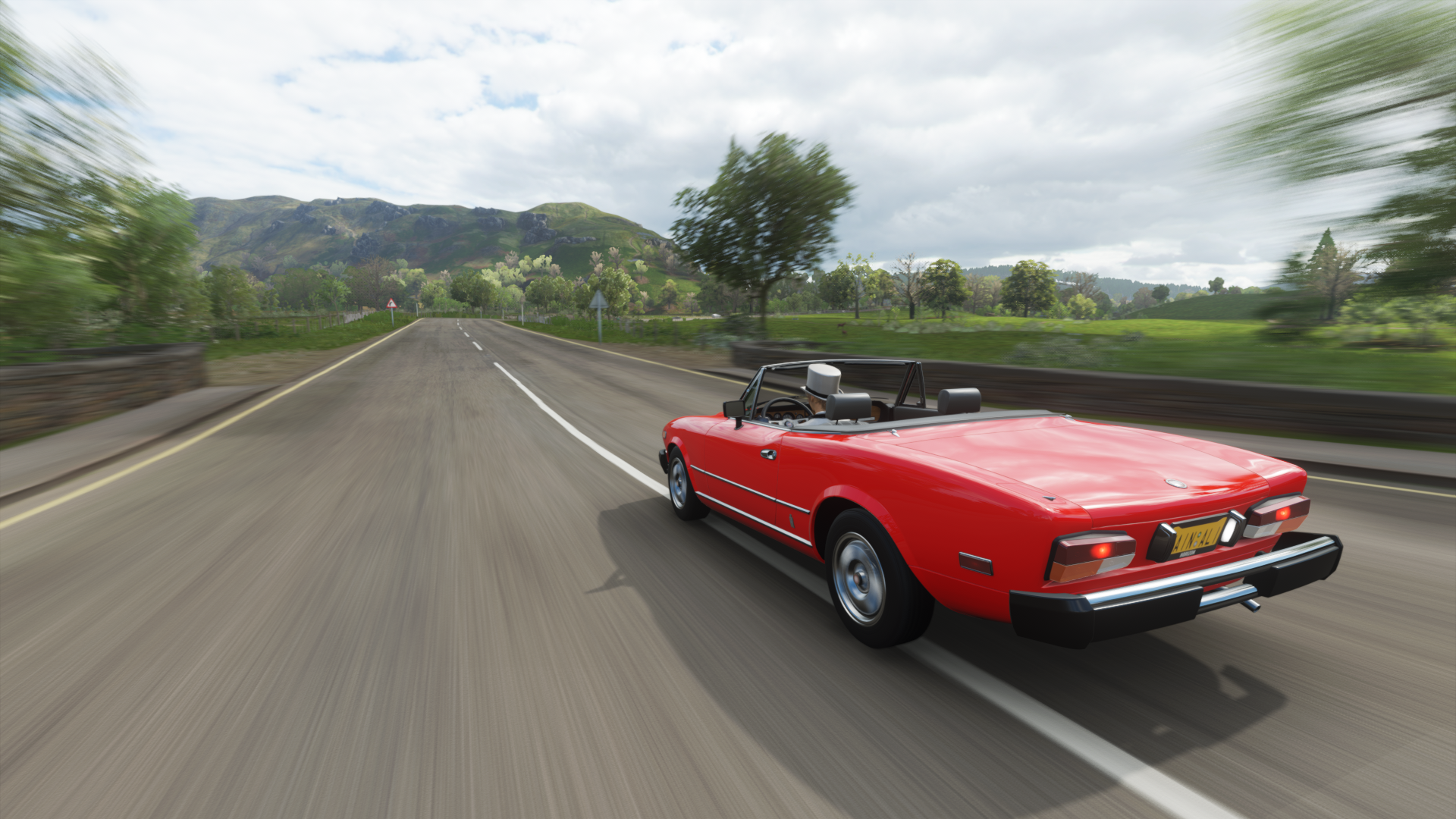 Red convertible sports car driving on a road in Forza Horizon 4 HD Wallpaper