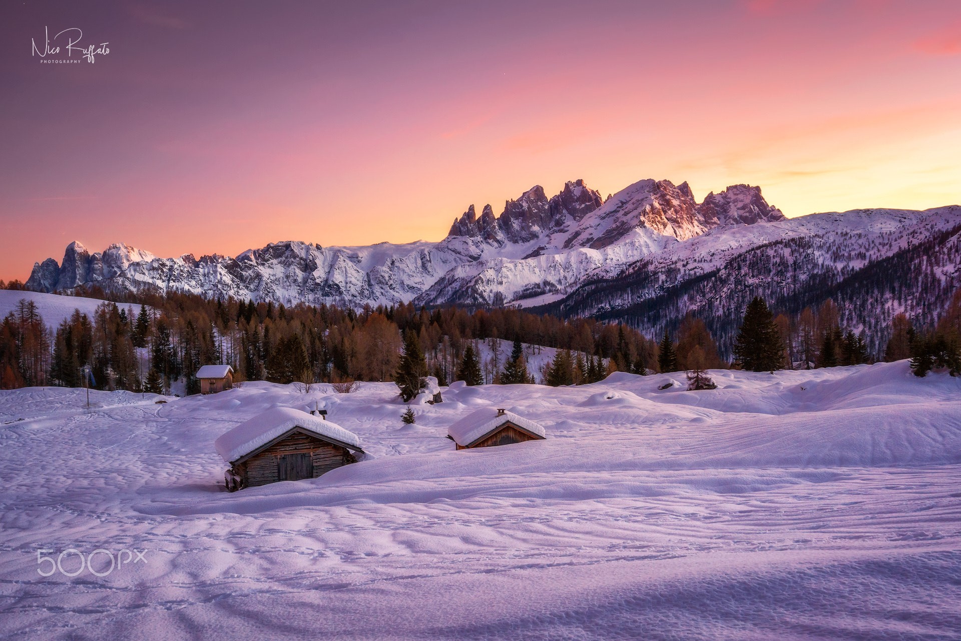 Snowy mountain landscape with cabins at sunset HD Wallpaper