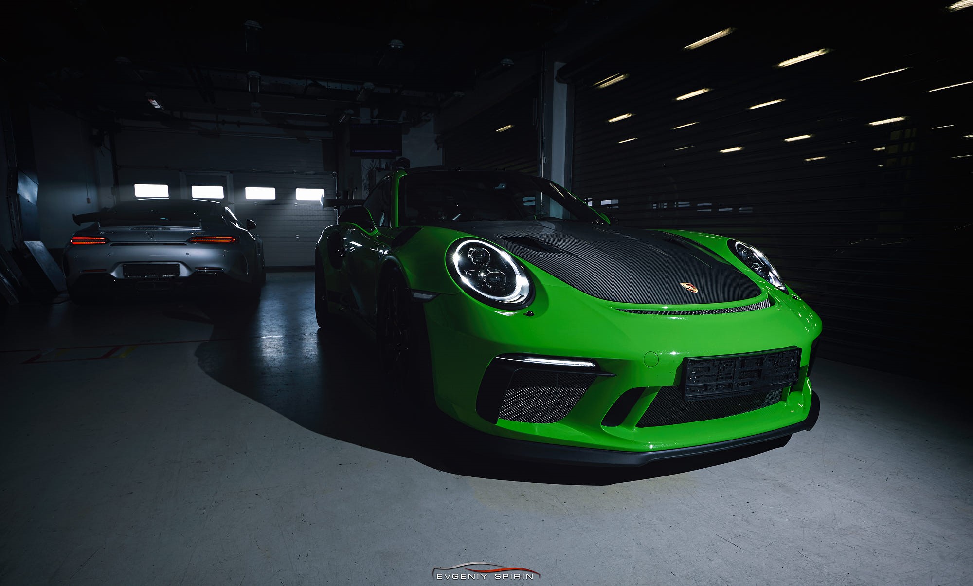 Green Porsche 911 and silver Mercedes-AMG GT in garage HD Wallpaper