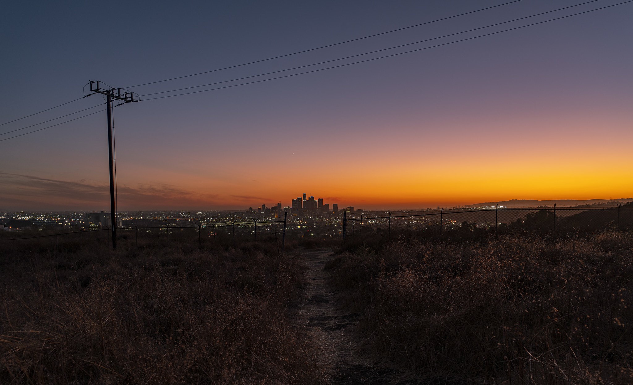 Los Angeles cityscape at dusk with power lines HD Wallpaper
