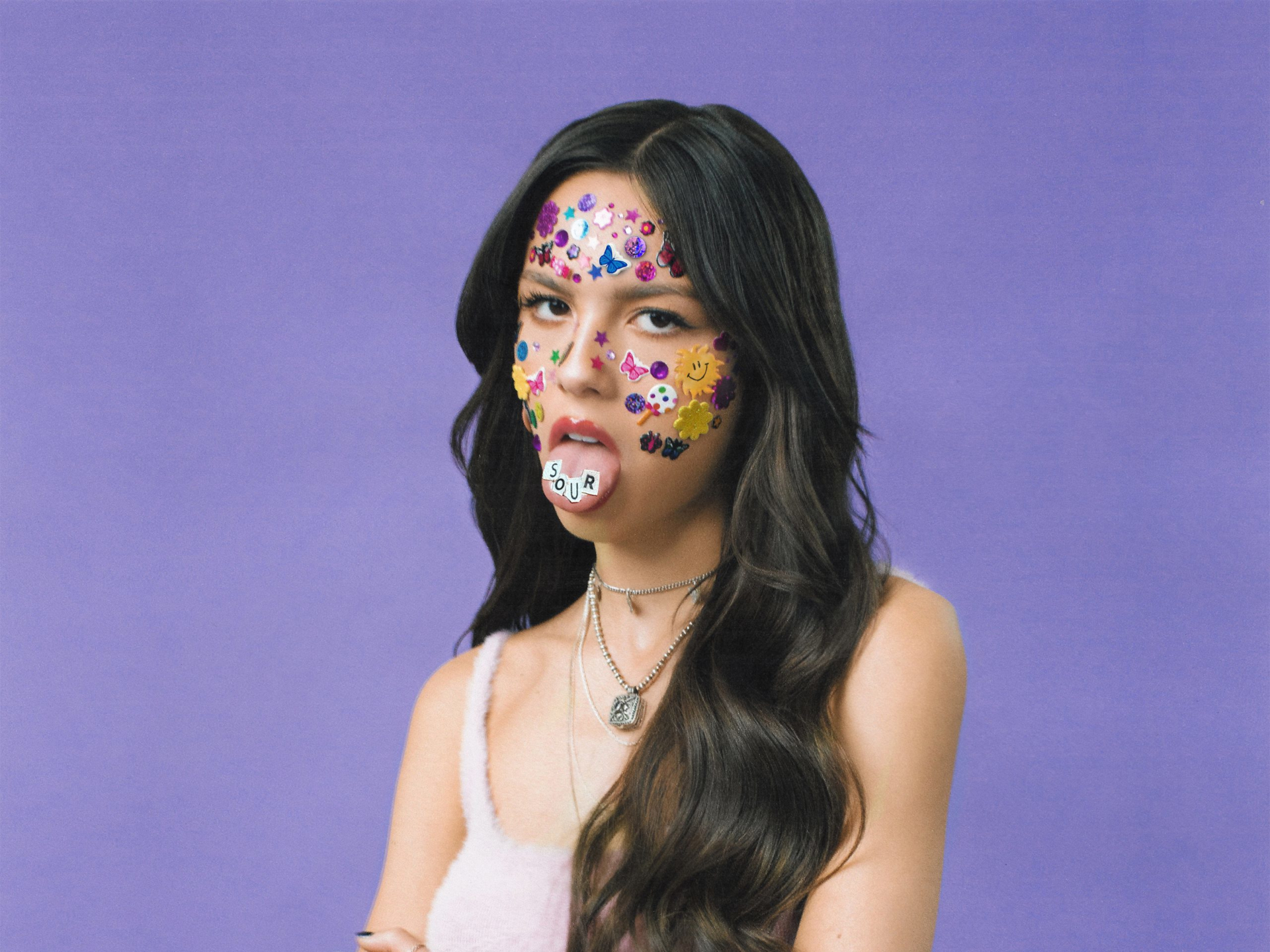Olivia Rodrigo with stickers on her face HD Wallpaper