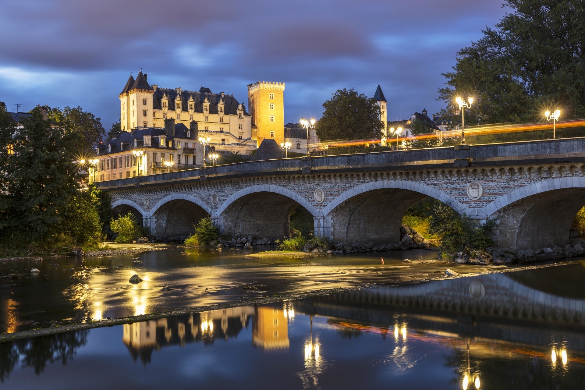 Bridge over river with castle and reflections at dusk HD Wallpaper