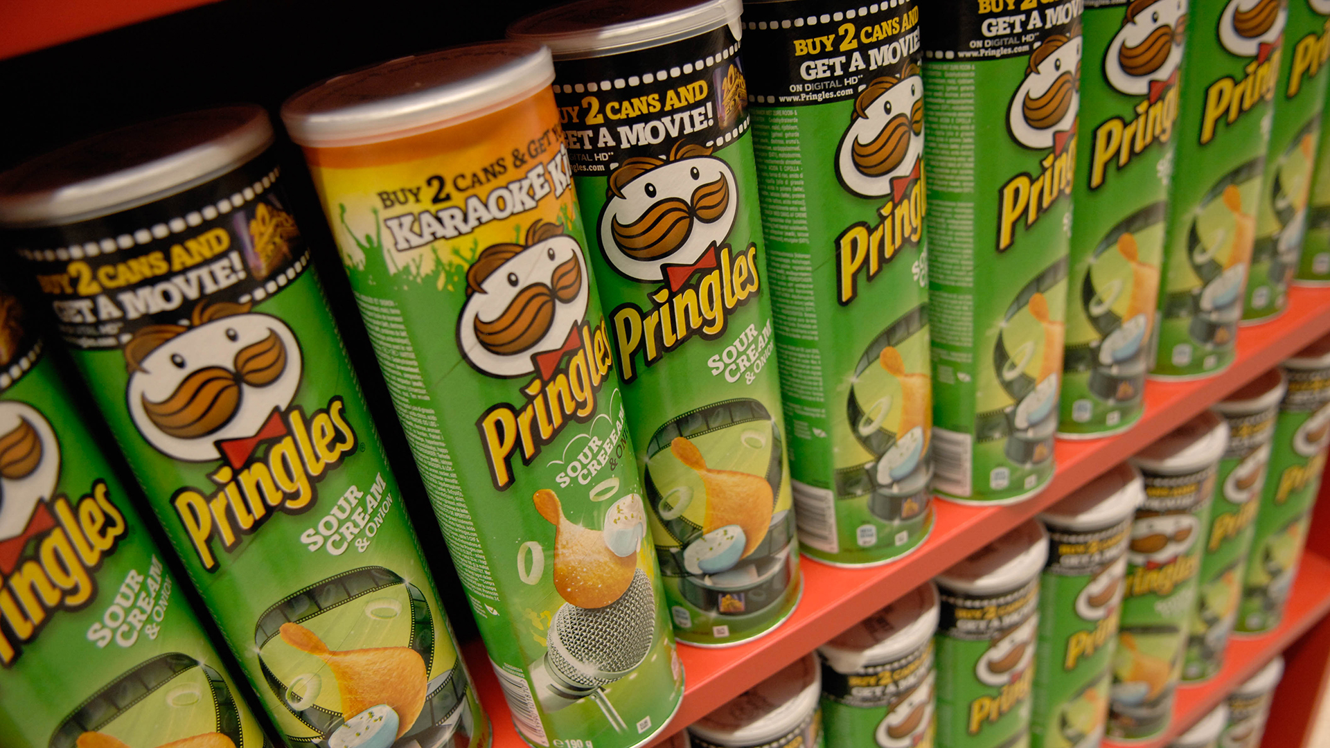 Pringles Sour Cream & Onion cans on display HD Wallpaper