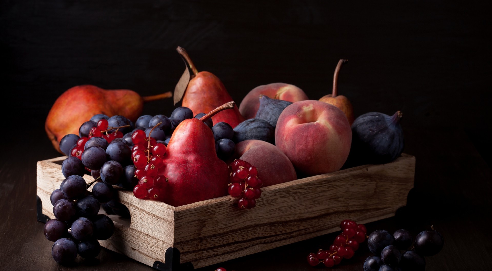 Still life of pears, peaches, figs, grapes, and red currants in a wooden crate HD Wallpaper