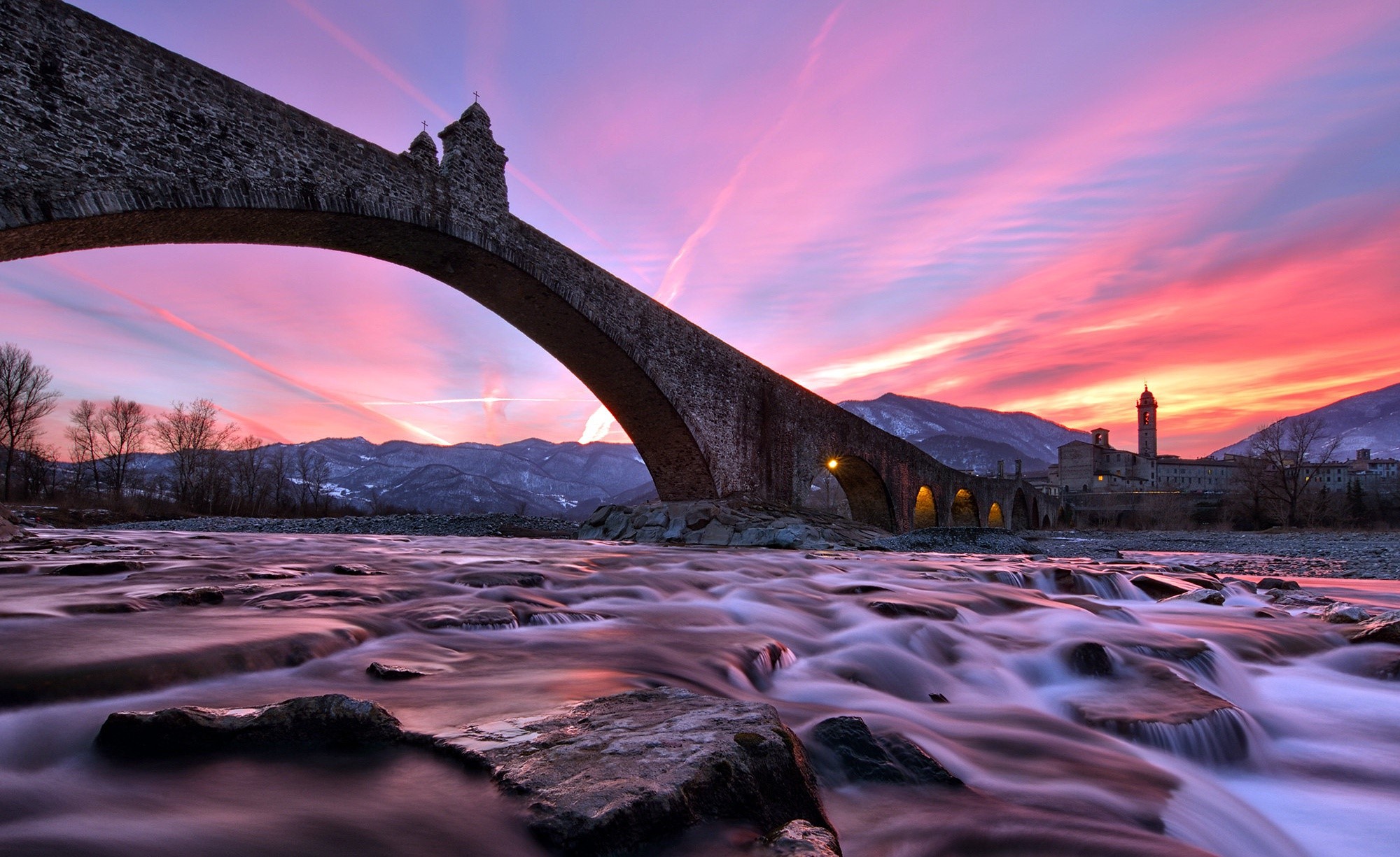 Stone bridge over a river at sunset in Italy HD Wallpaper