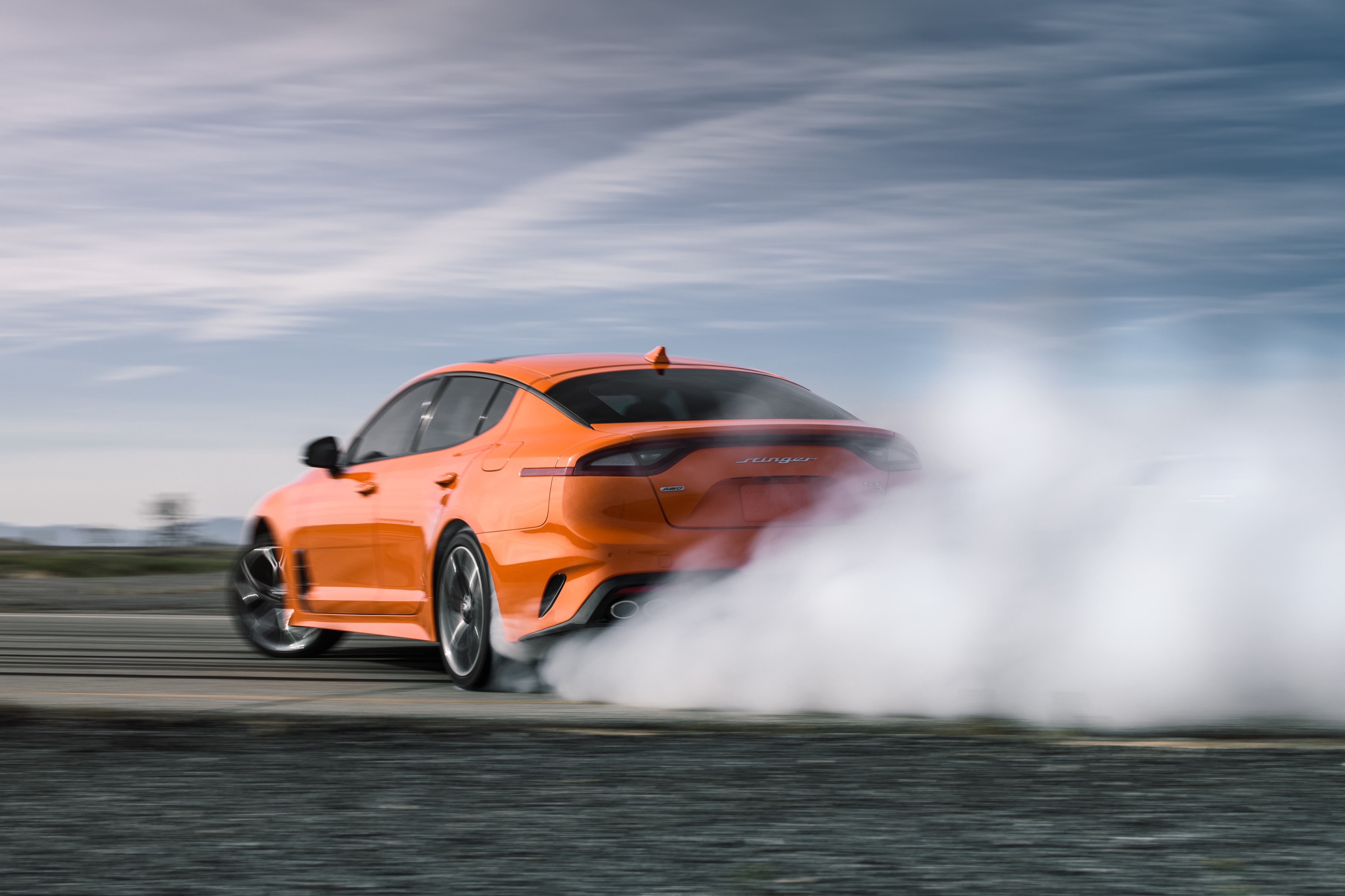 Orange Kia Stinger GT drifting with smoke HD Wallpaper