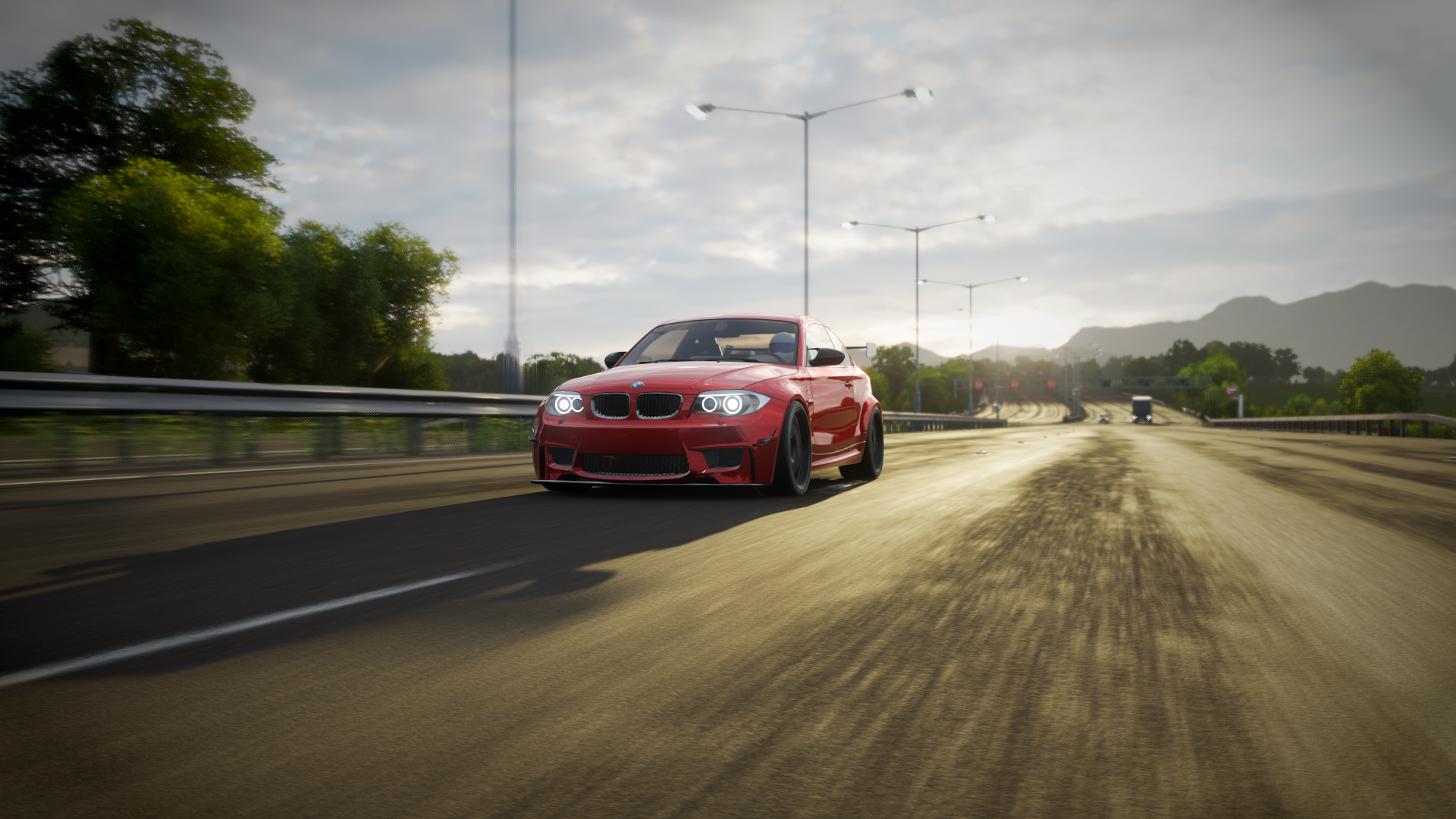 Red BMW 1 Series M Coupe driving on a highway in Forza Horizon 4 HD Wallpaper
