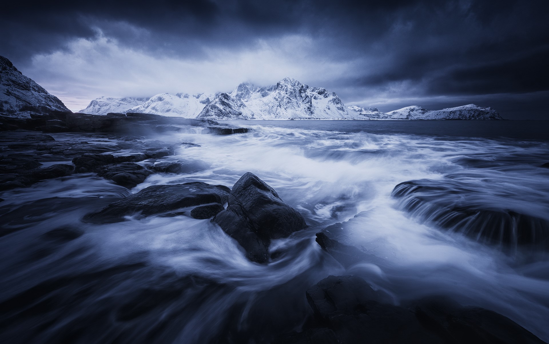 Snowy mountains and waves crashing on rocks HD Wallpaper