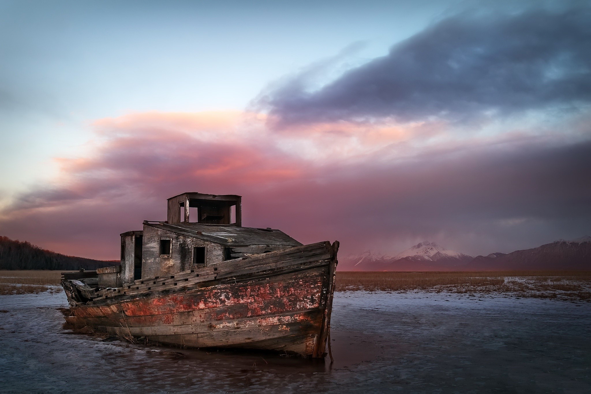 Abandoned wooden boat on frozen ground at sunset HD Wallpaper