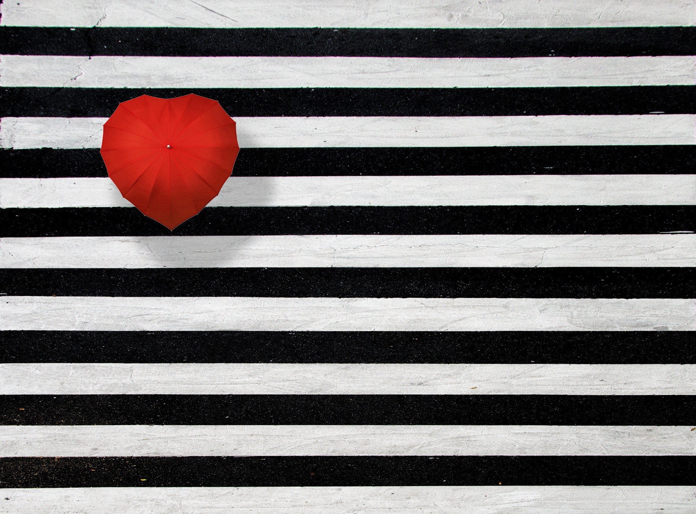 Red heart-shaped umbrella on black and white stripes HD Wallpaper