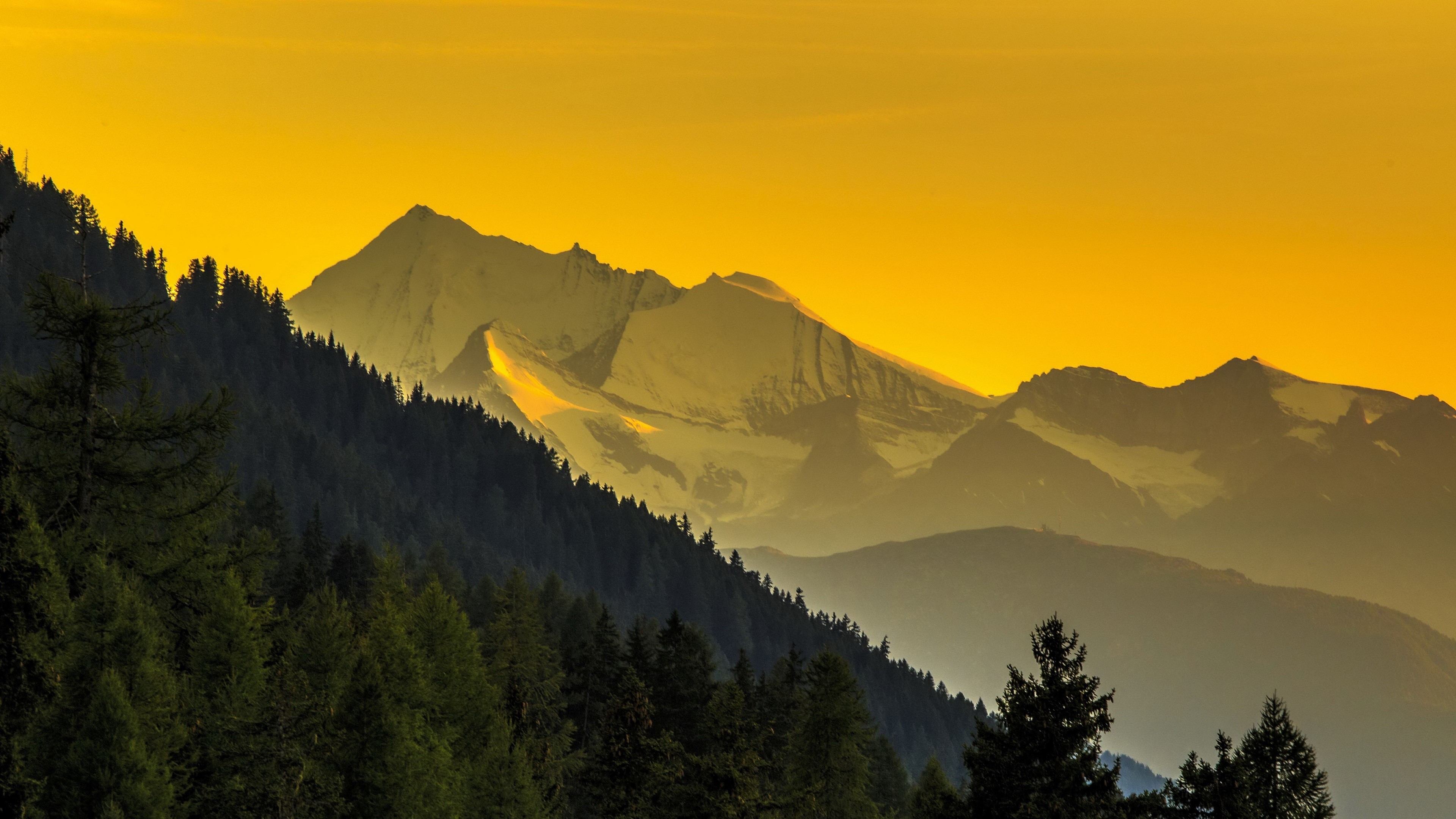 Snowy mountains and forest at sunset HD Wallpaper