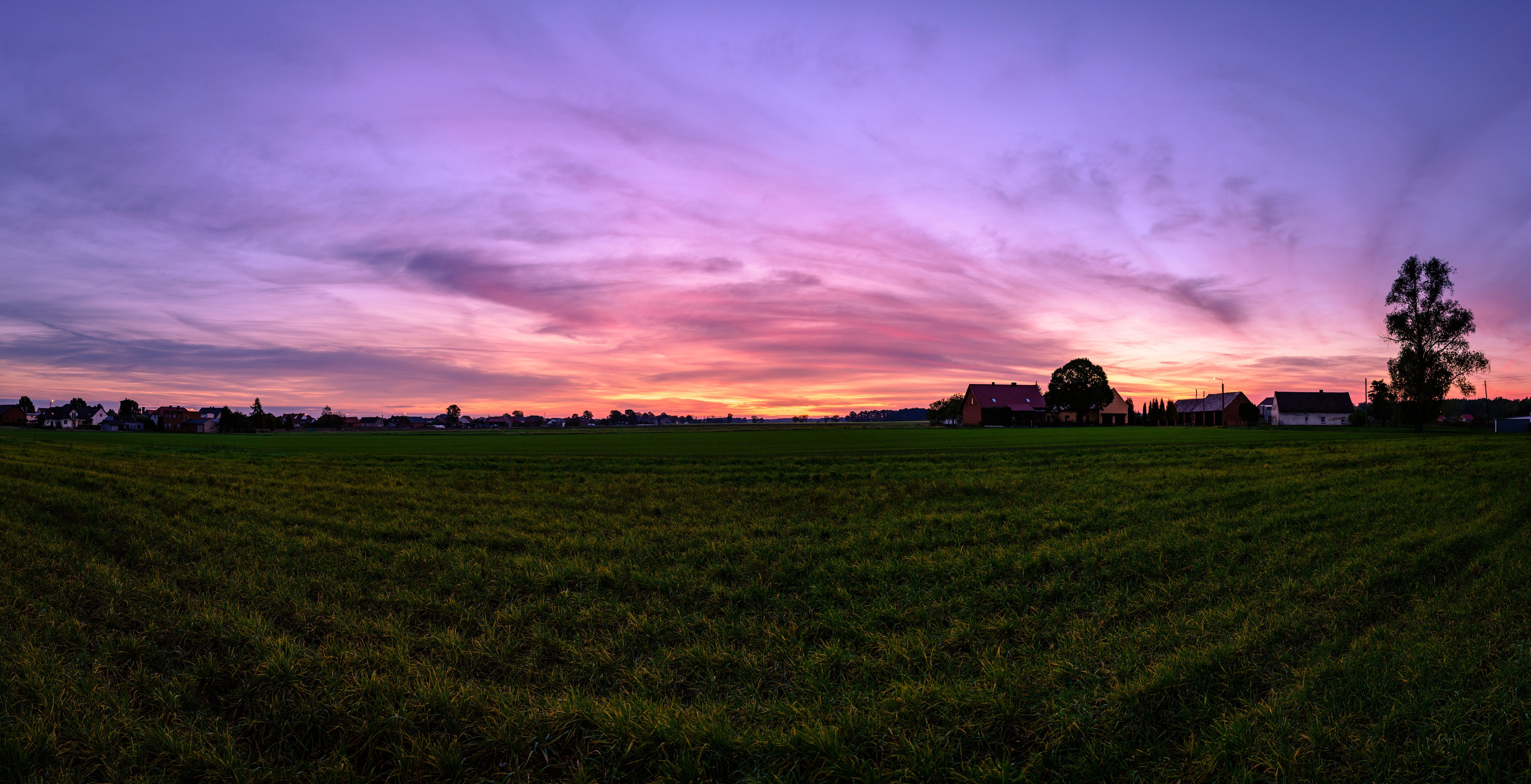Panorama of a village at sunset with orange sky HD Wallpaper