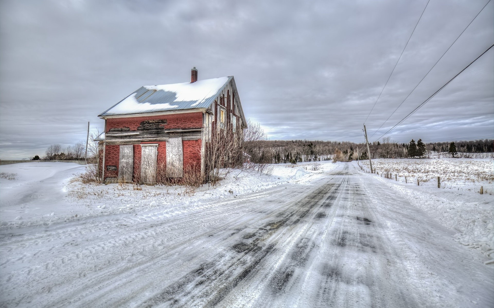 Abandoned brick house in winter by a snowy road HD Wallpaper
