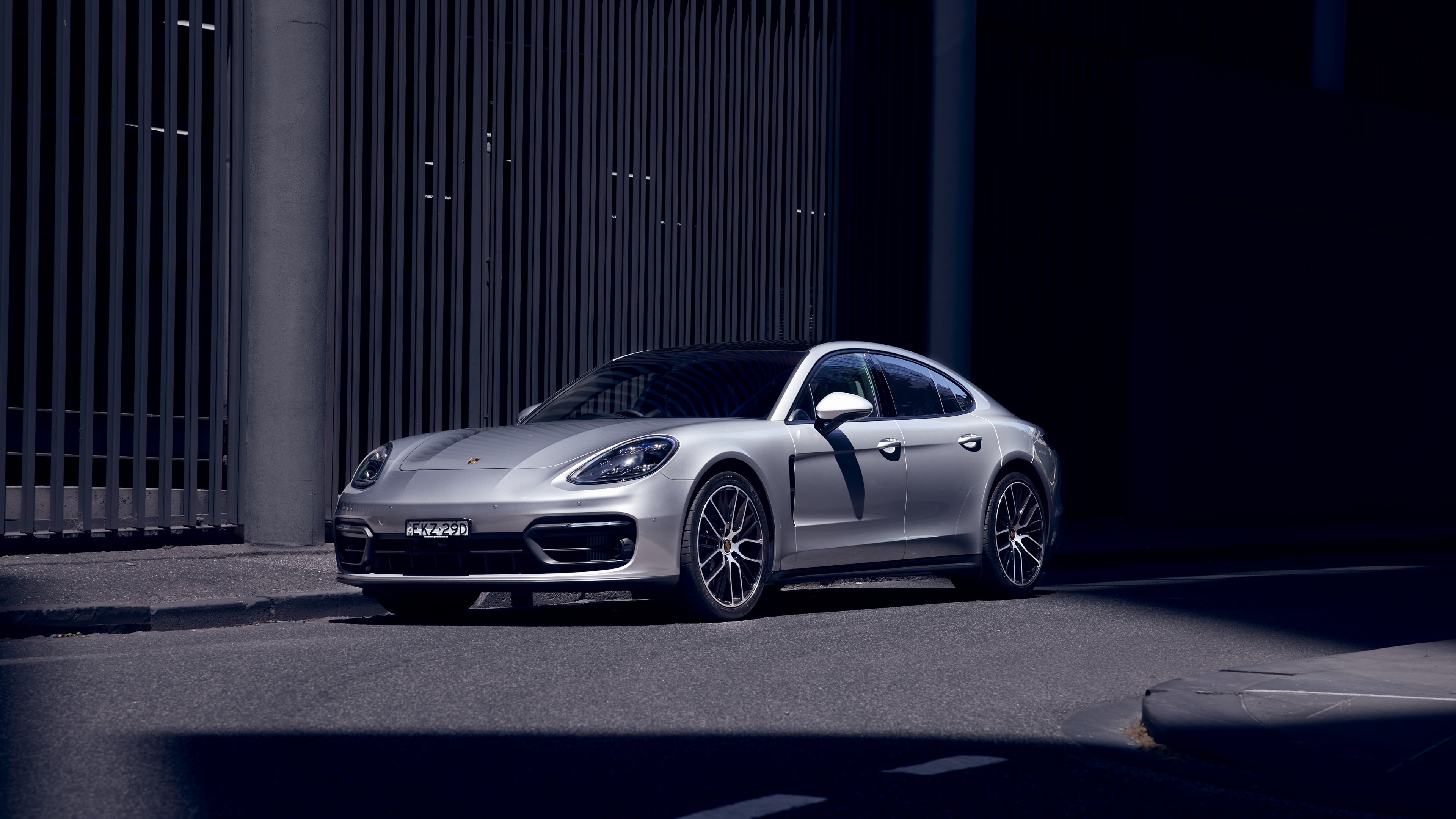 Silver Porsche Panamera parked on street HD Wallpaper
