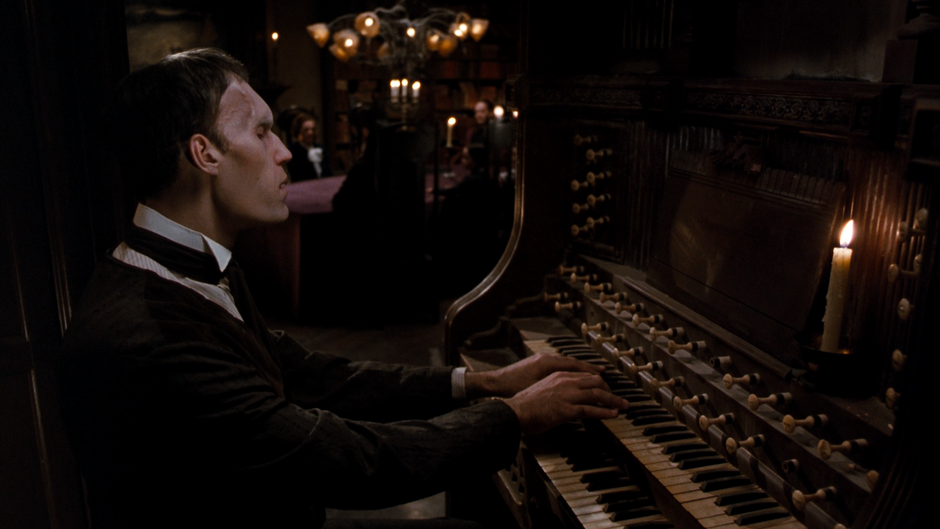 Lurch playing the organ in a dimly lit room HD Wallpaper