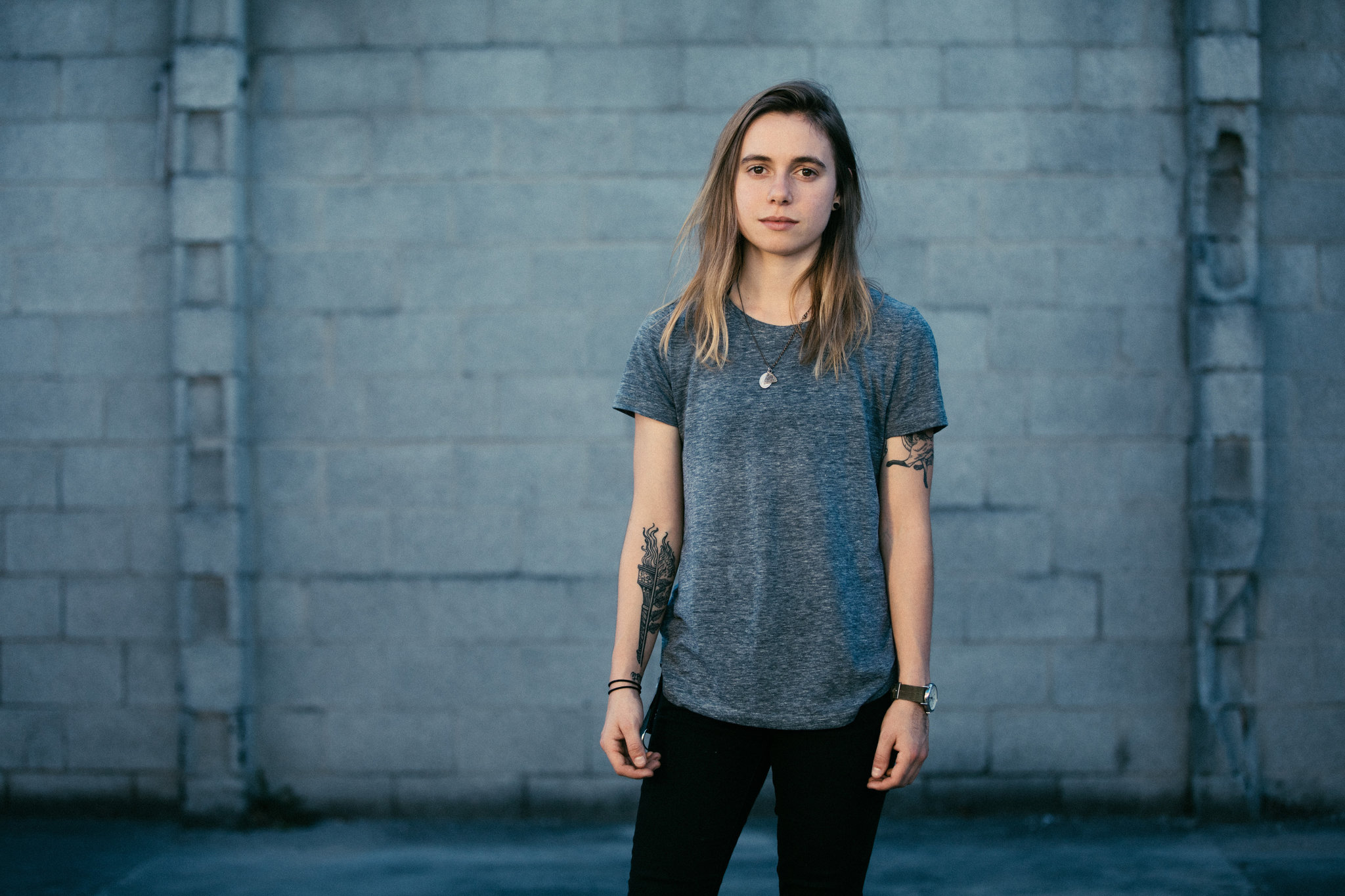 Julien Baker standing in front of a brick wall HD Wallpaper