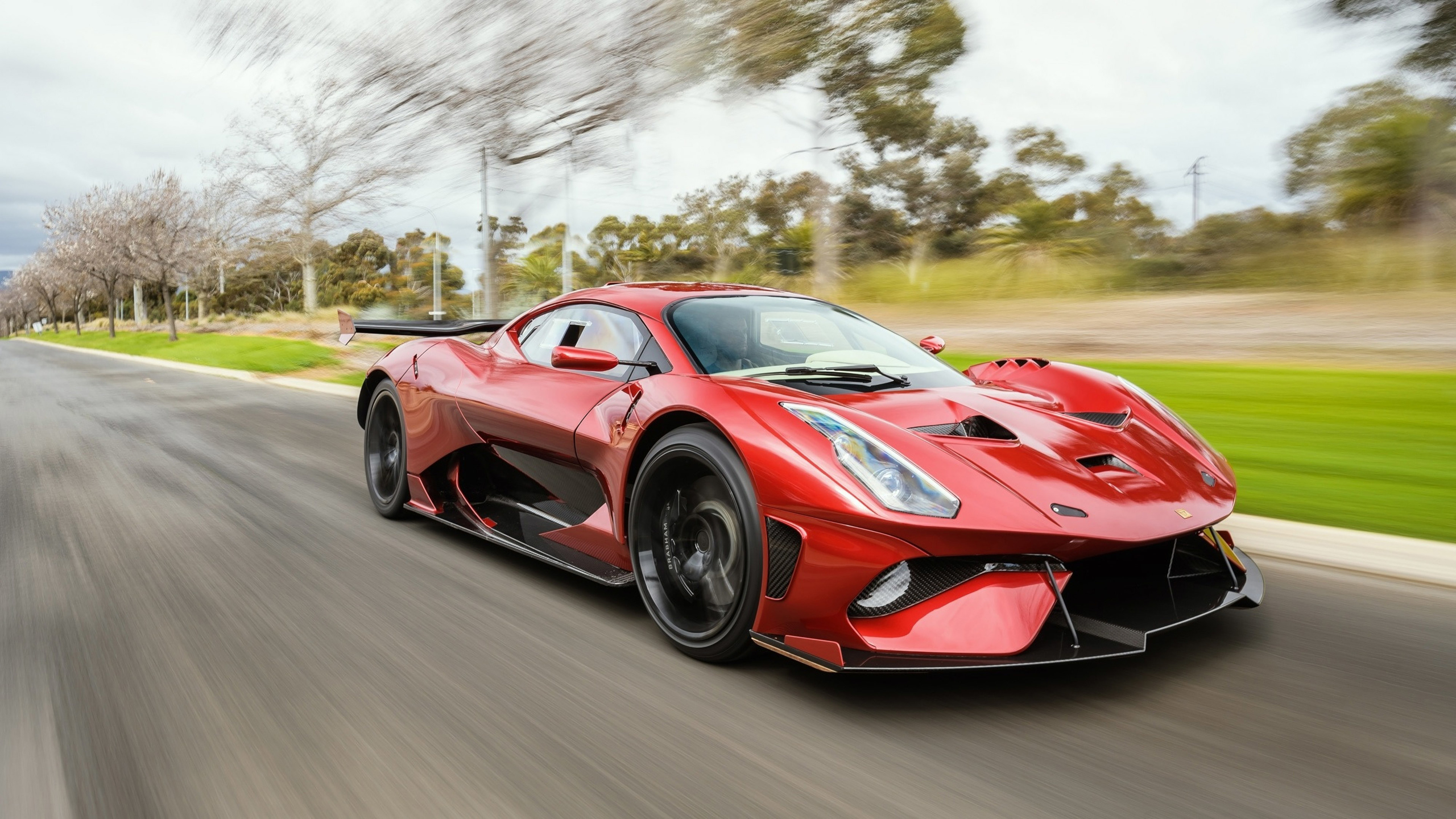 Red Brabham BT62R Driving on a Road HD Wallpaper