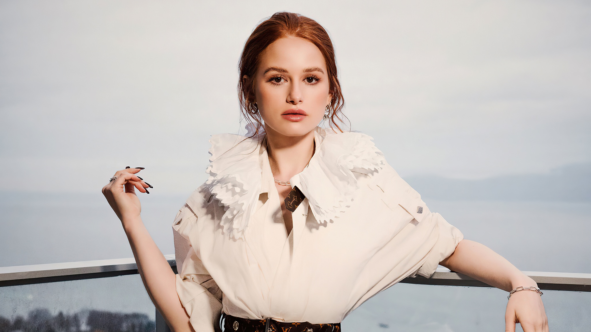 Madelaine Petsch posing outdoors with a scenic background HD Wallpaper