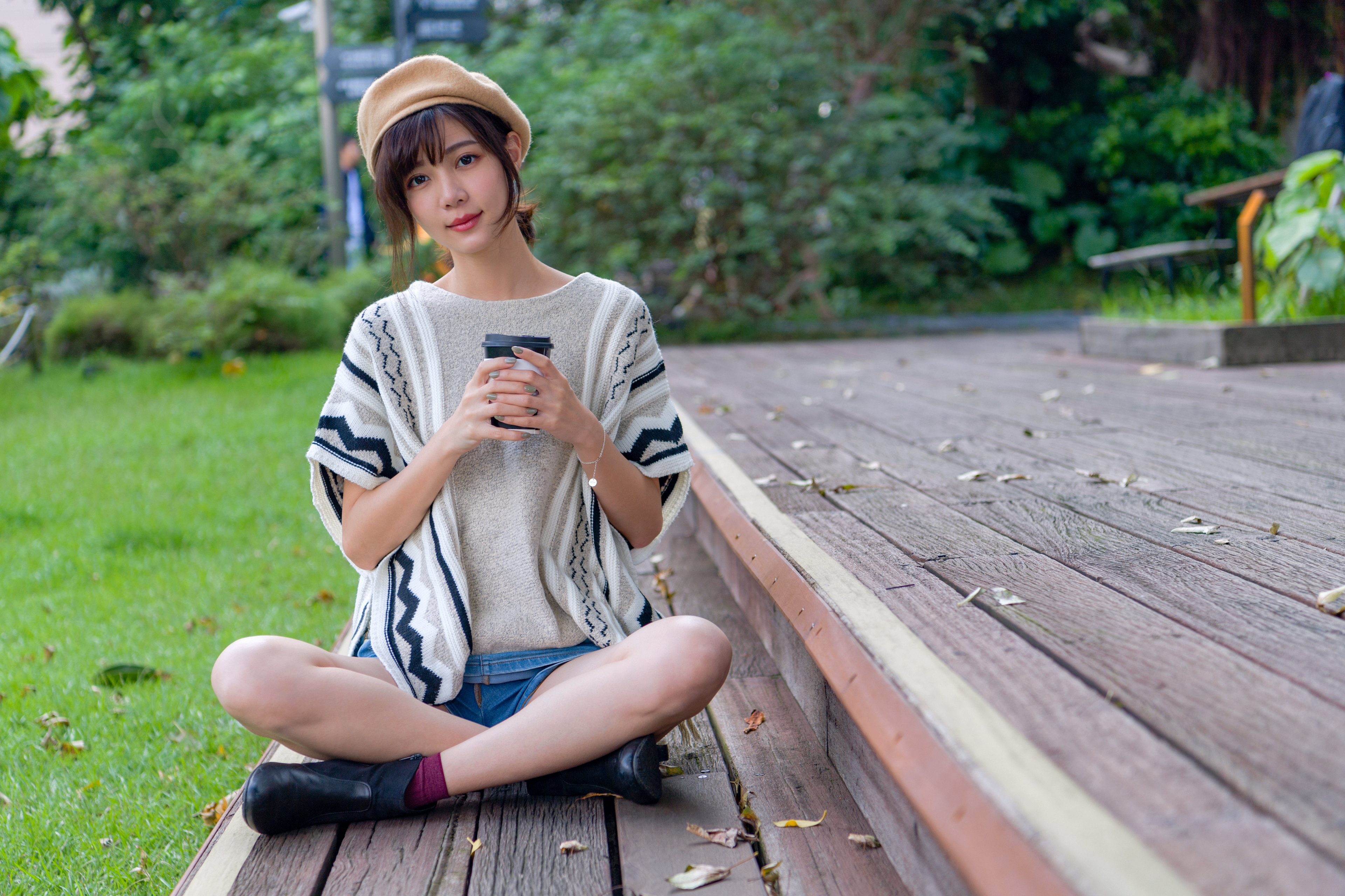 Asian woman with coffee cup in park HD Wallpaper