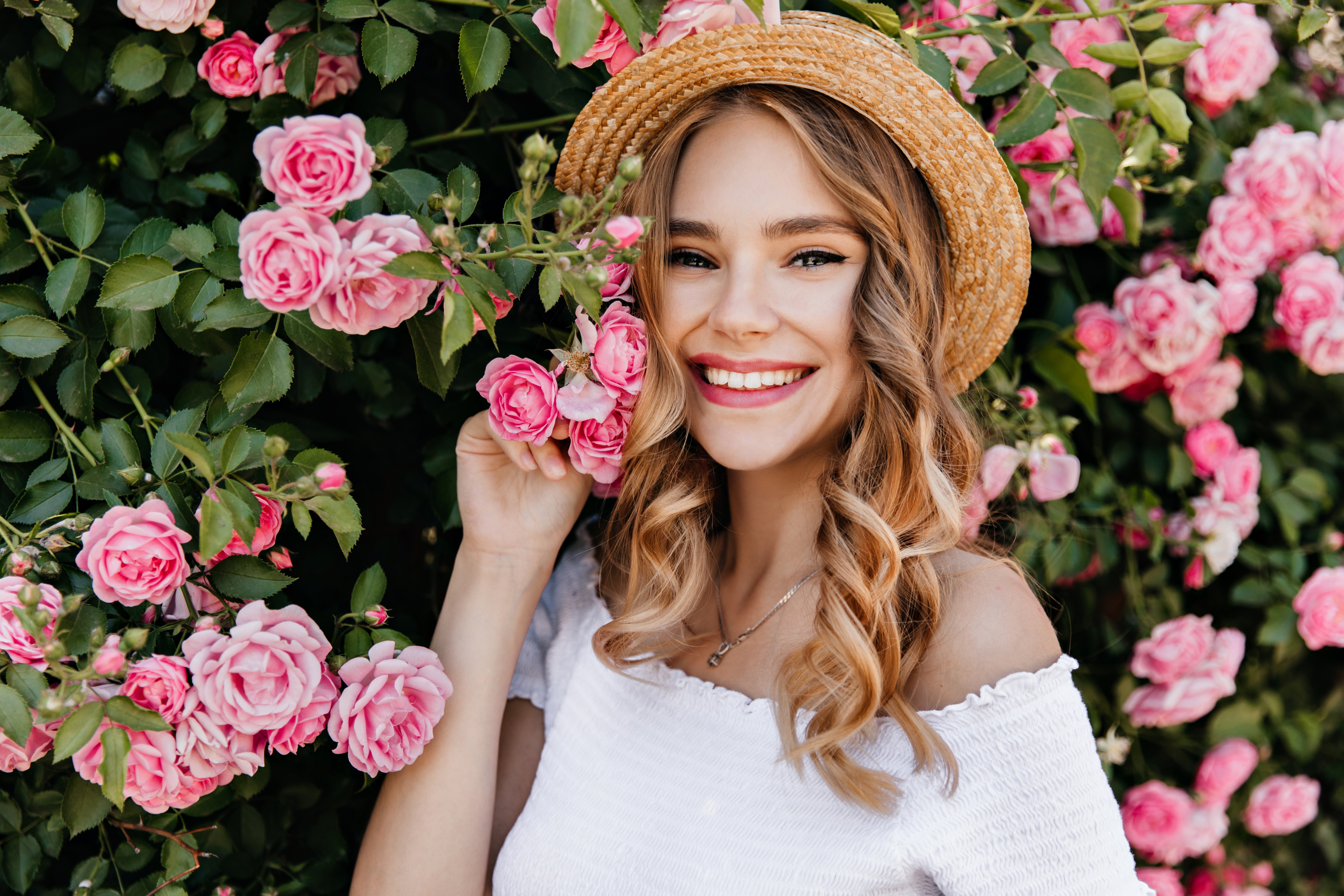 Woman in Straw Hat Poses with Pink Roses HD Wallpaper