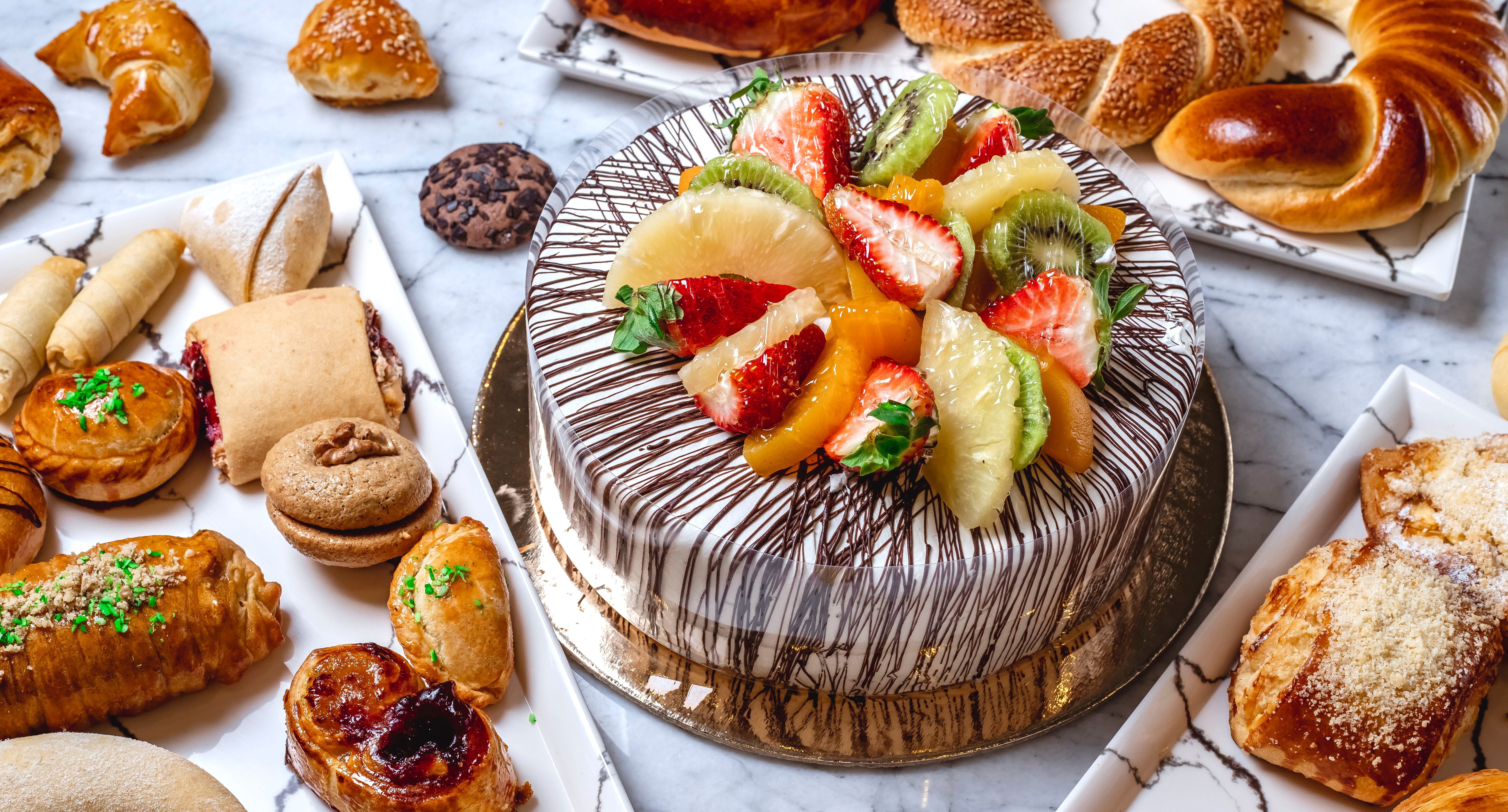 Cake and pastries on a marble table HD Wallpaper