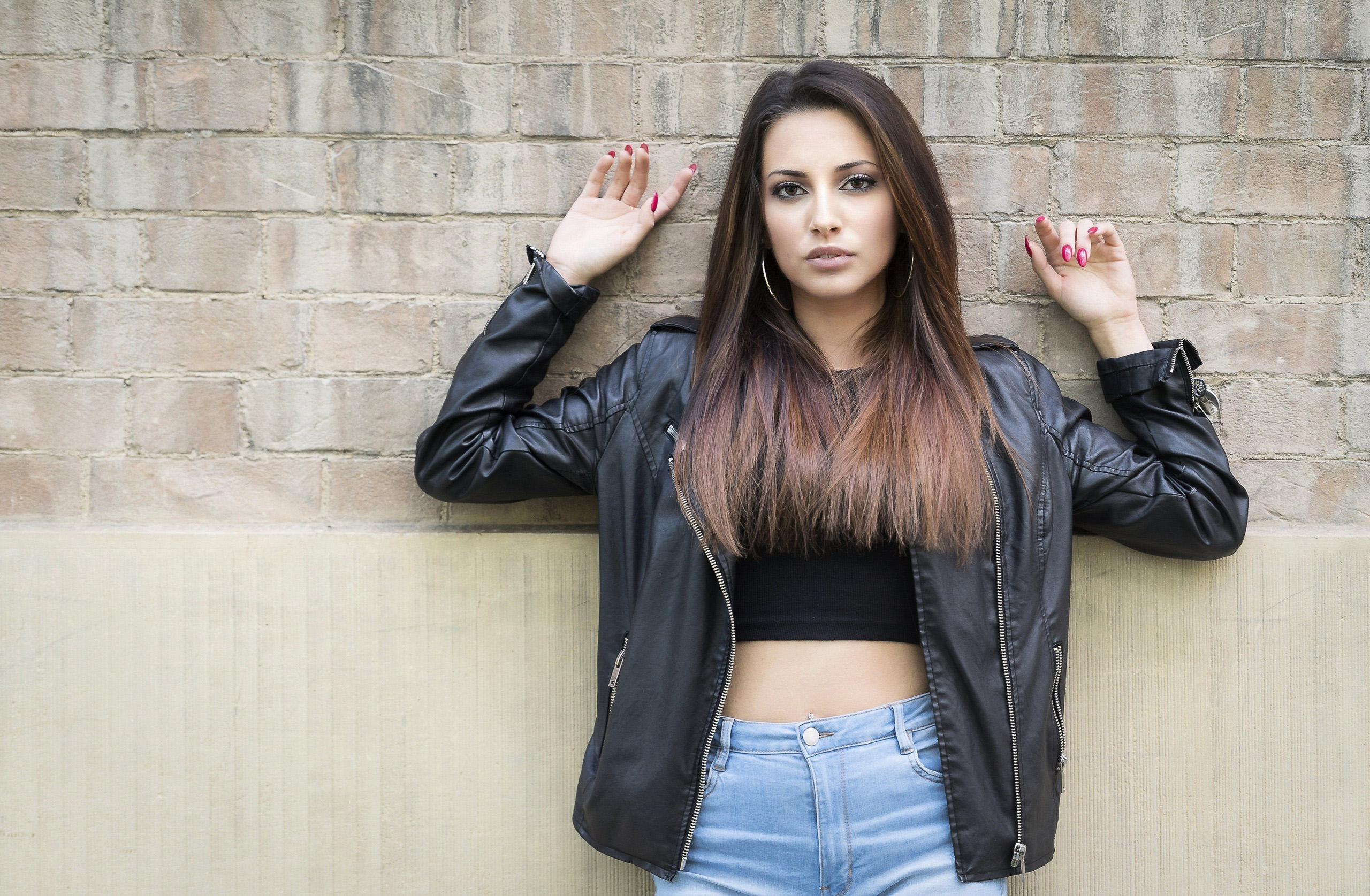 Woman in Leather Jacket Posing Against Wall HD Wallpaper