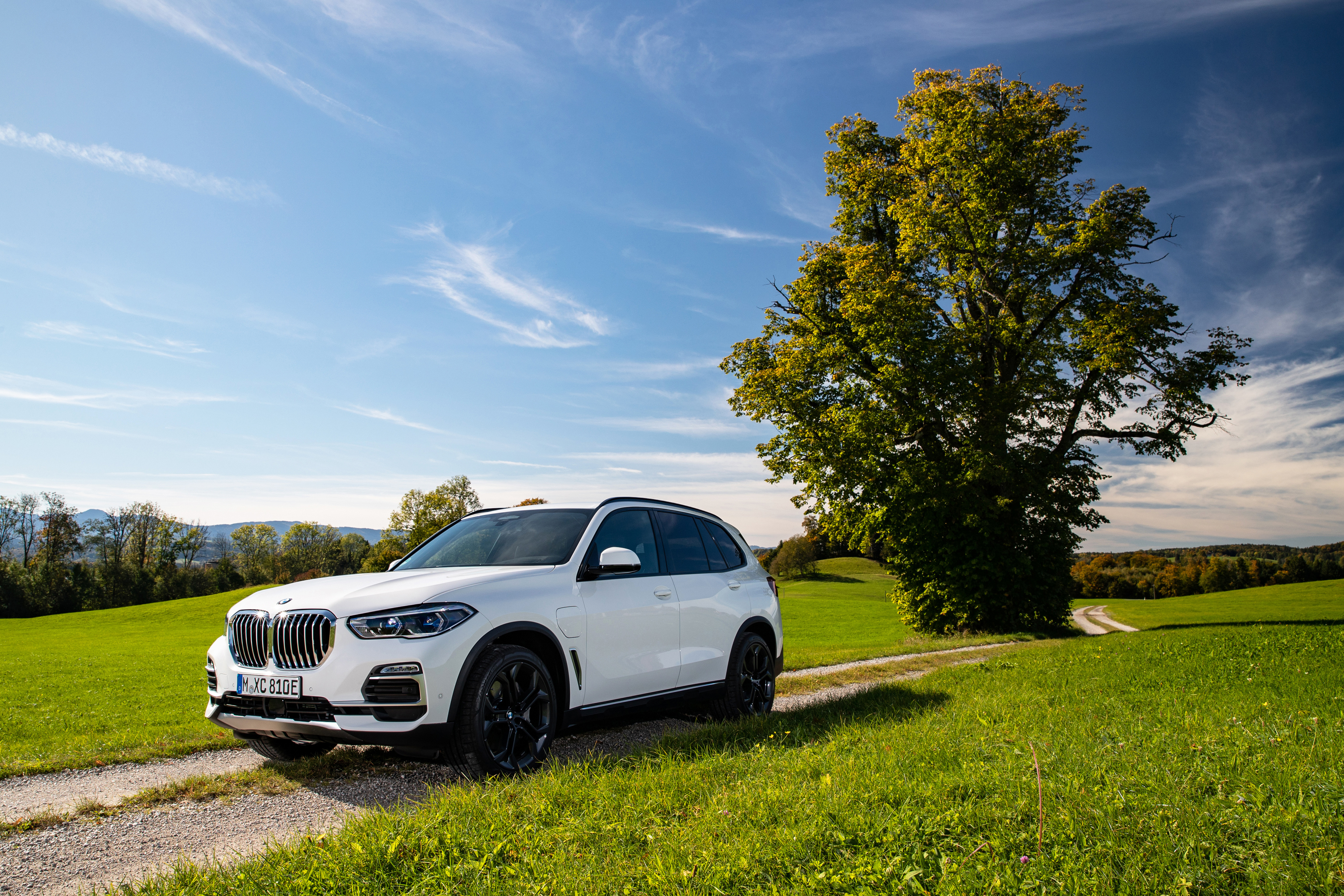 White BMW X5 SUV on a dirt road HD Wallpaper