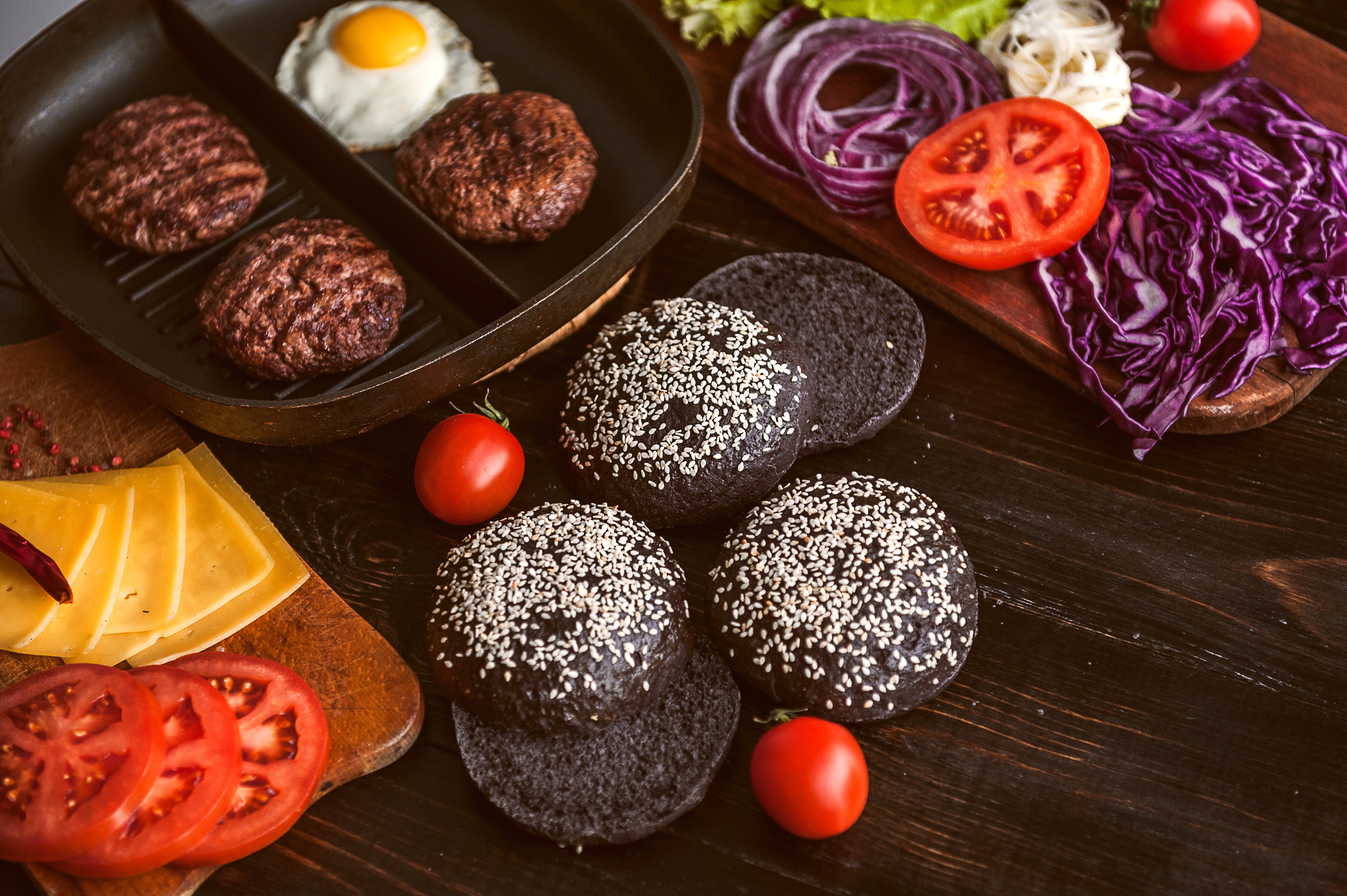 Burger Ingredients on a Dark Wooden Table HD Wallpaper